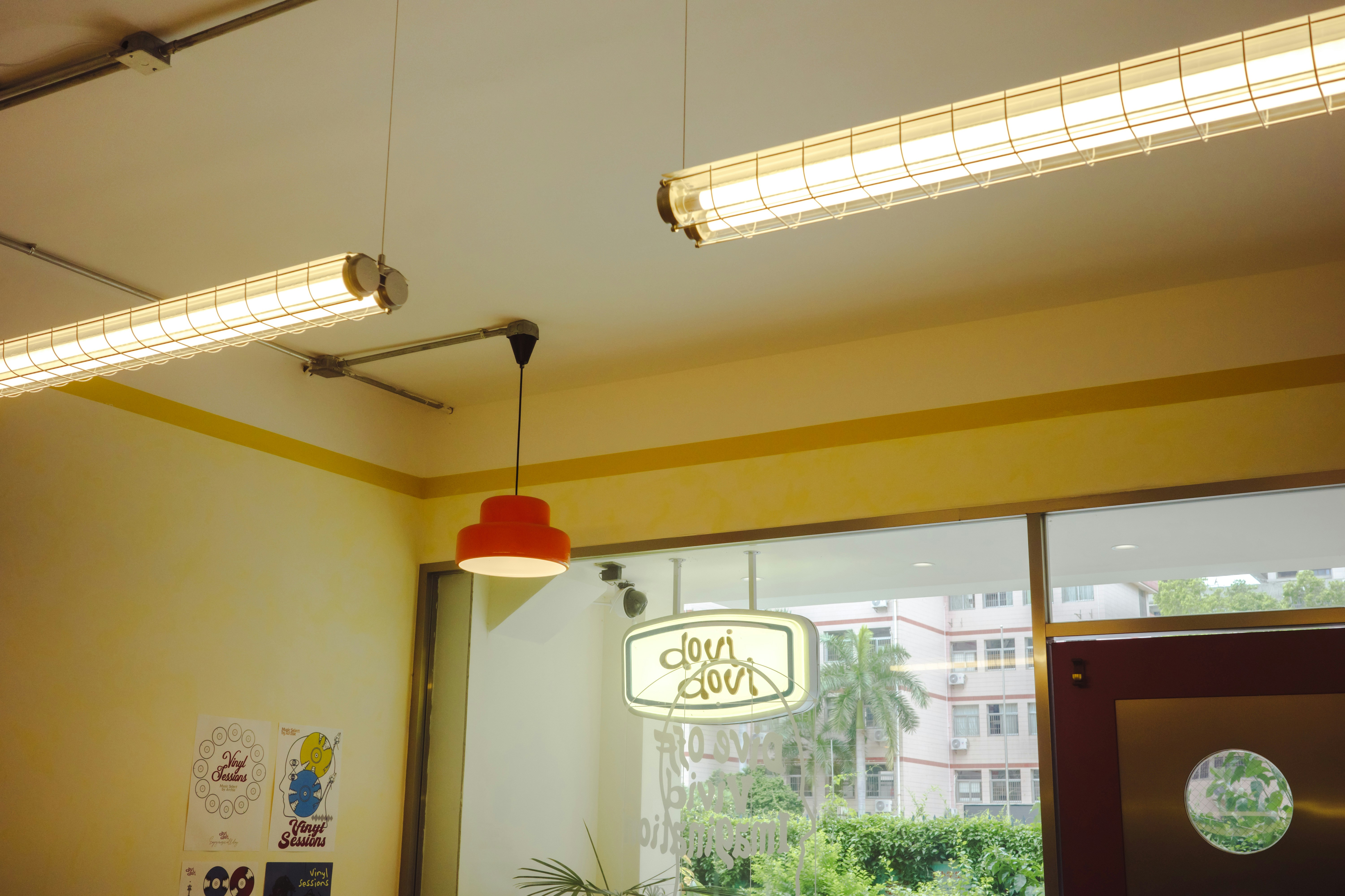 Two fluorescent lights and a red pendant lamp.