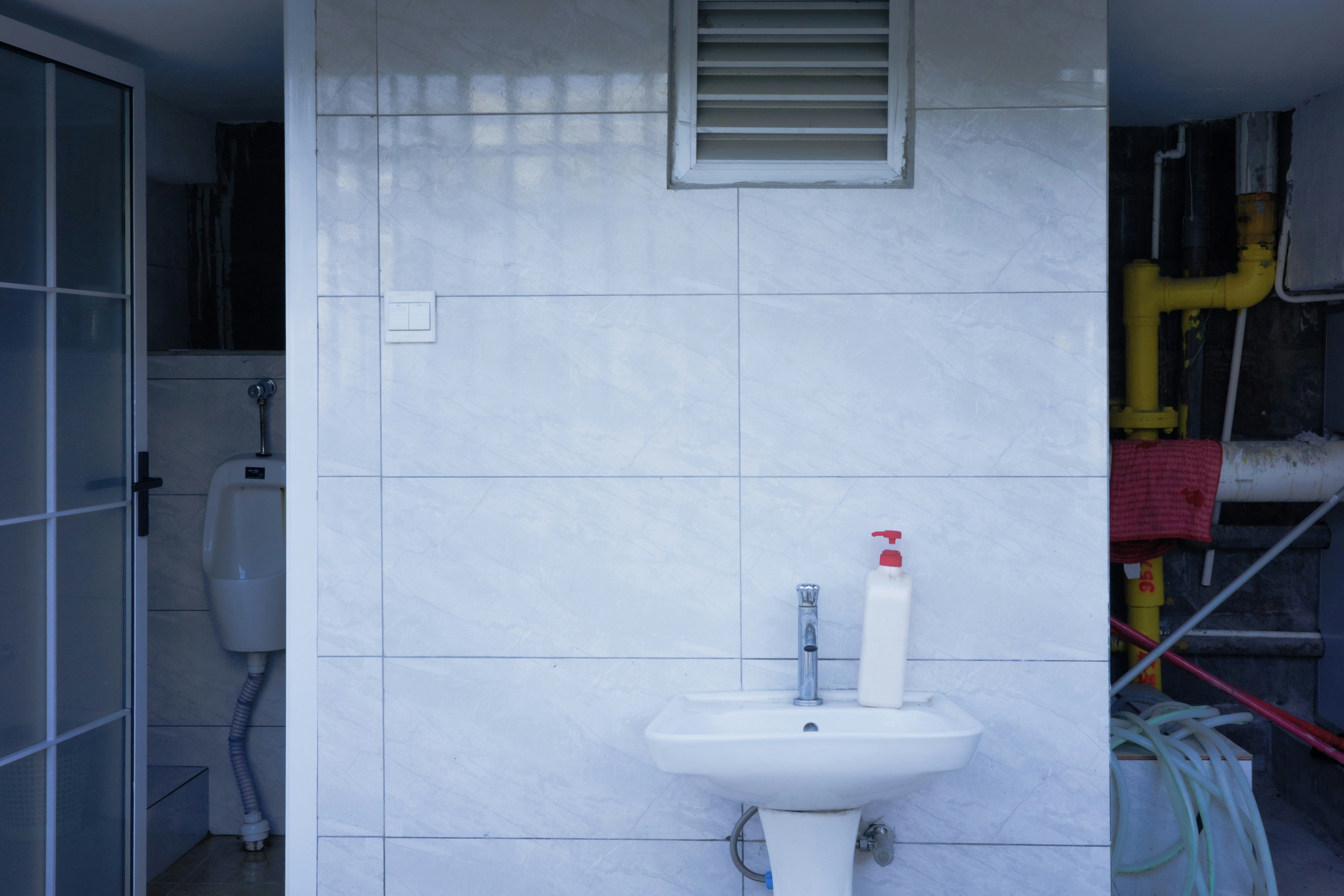 Drain cleaning pipe work in utility room