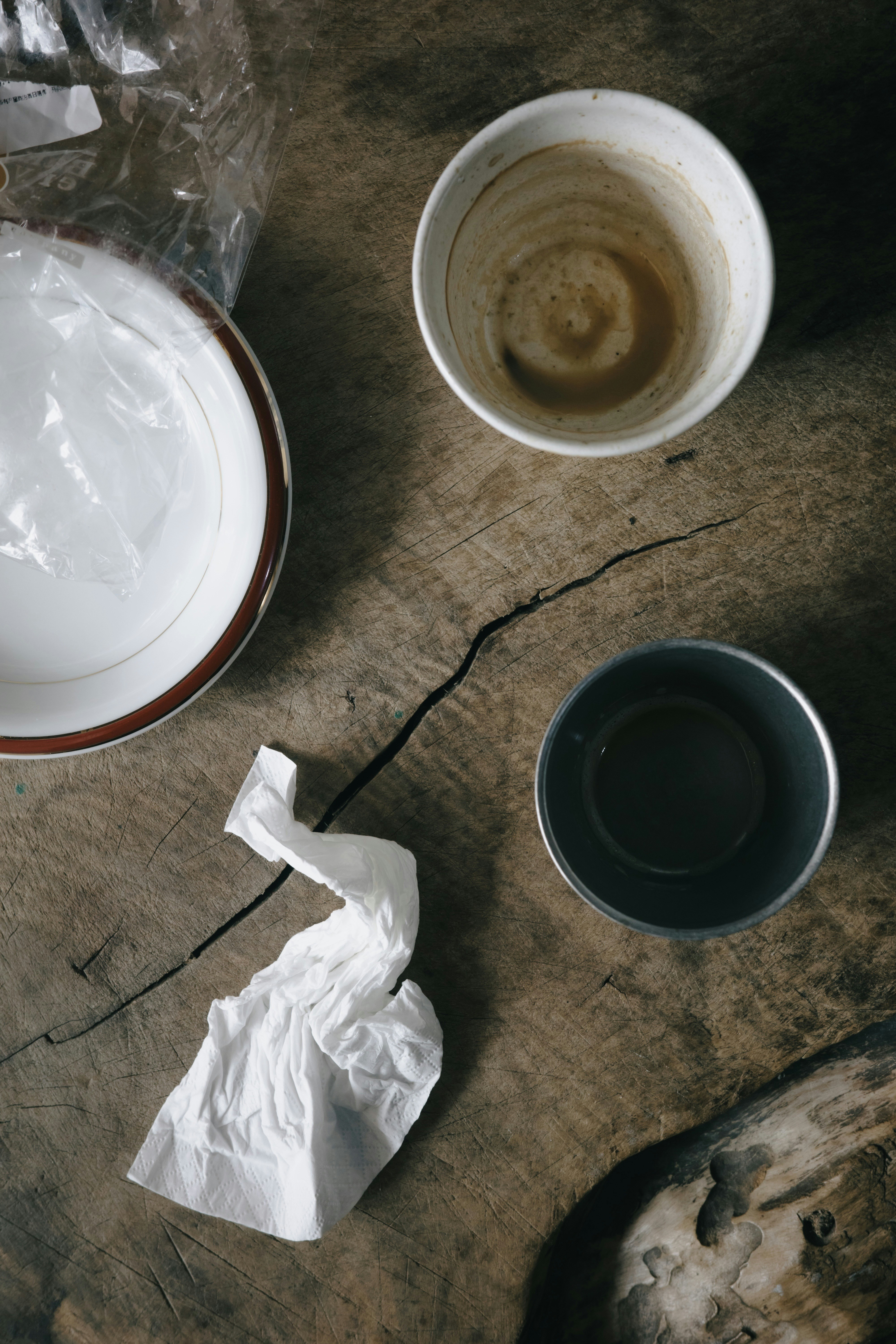 Dirty dishes and crumpled napkin on wooden table