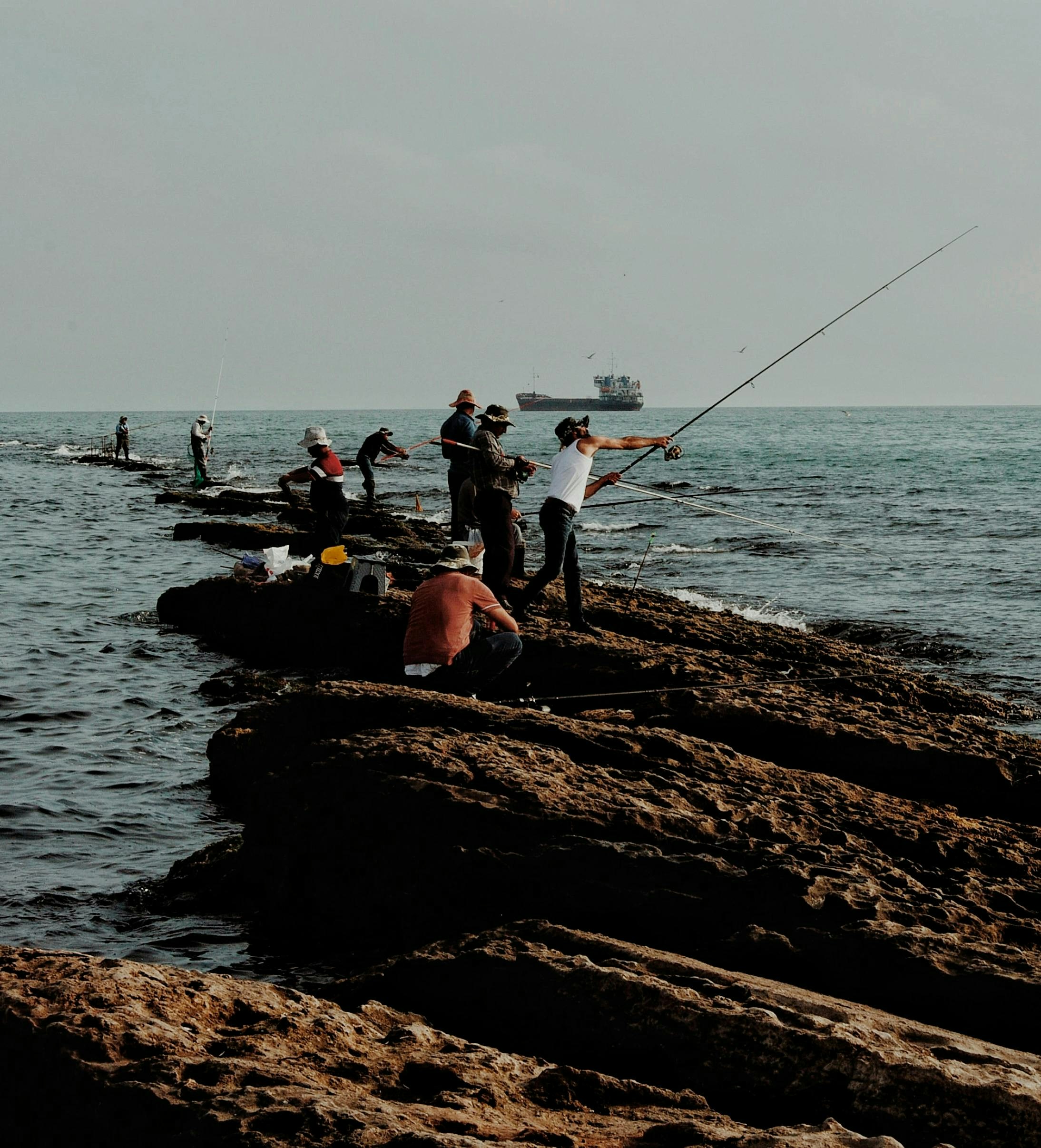 Fishermen casting lines from rocks into the ocean. photo – Free Sport ...