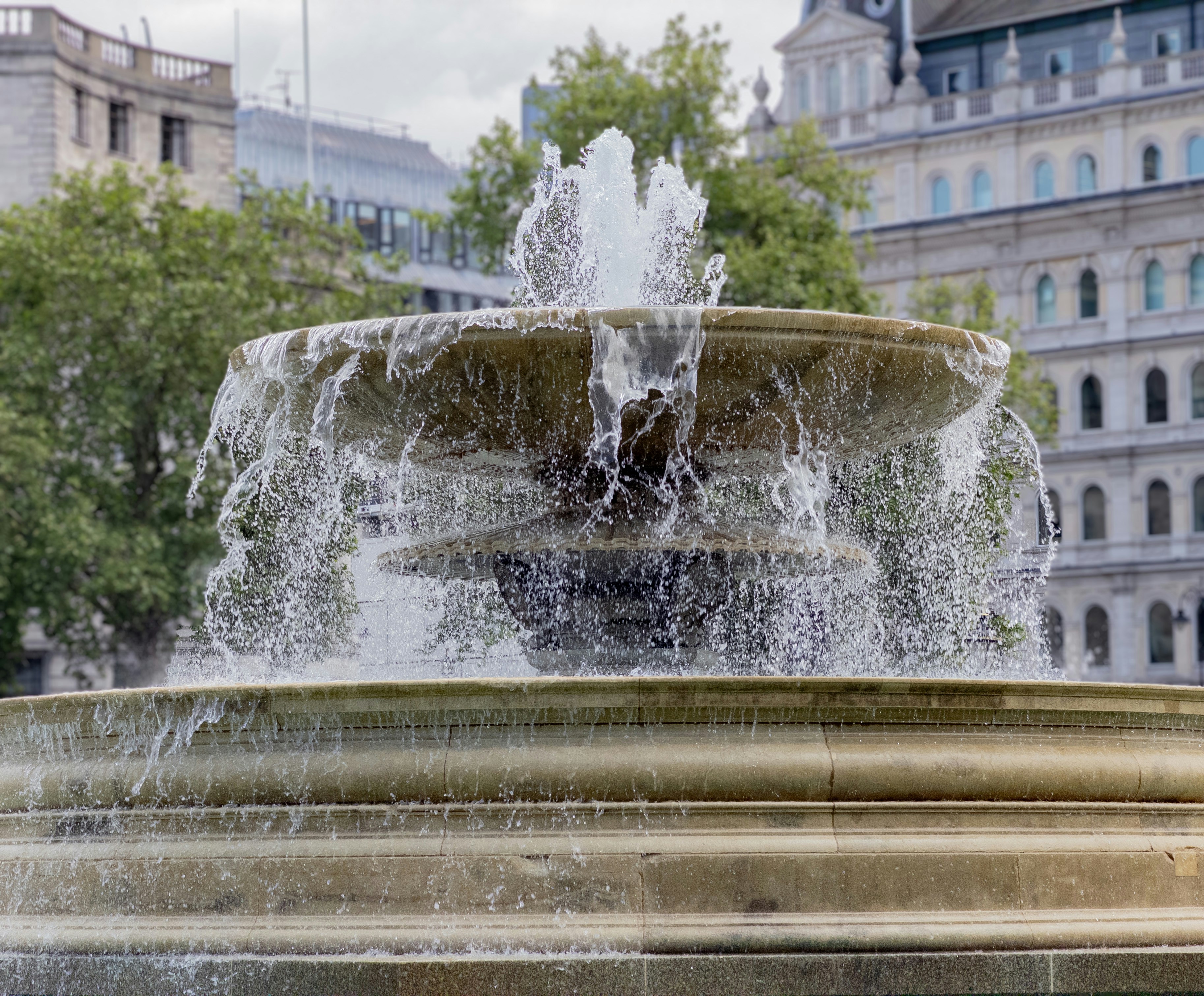A large ornate fountain spraying water in a city