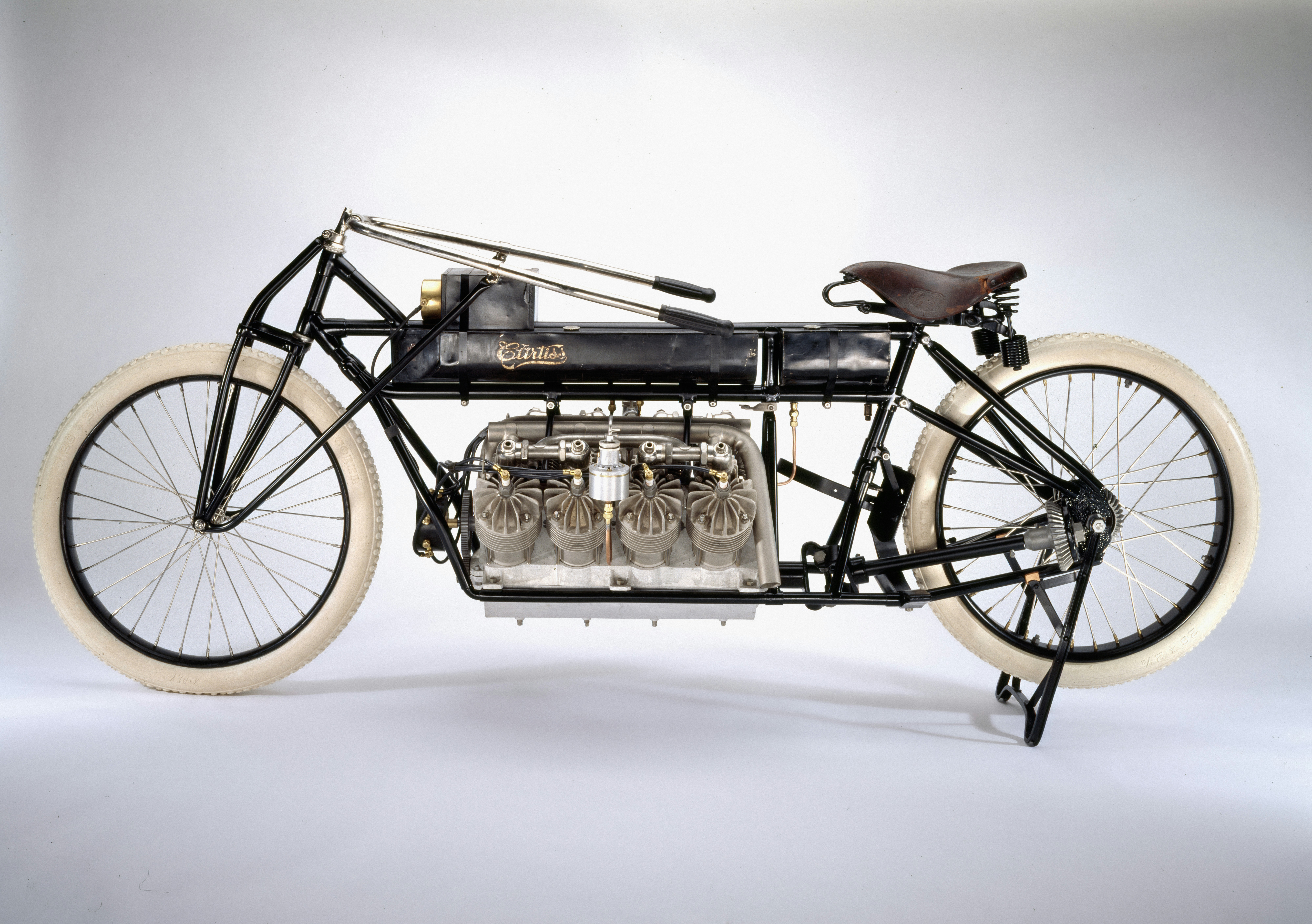 Vintage motorcycle with a large engine and white tires.