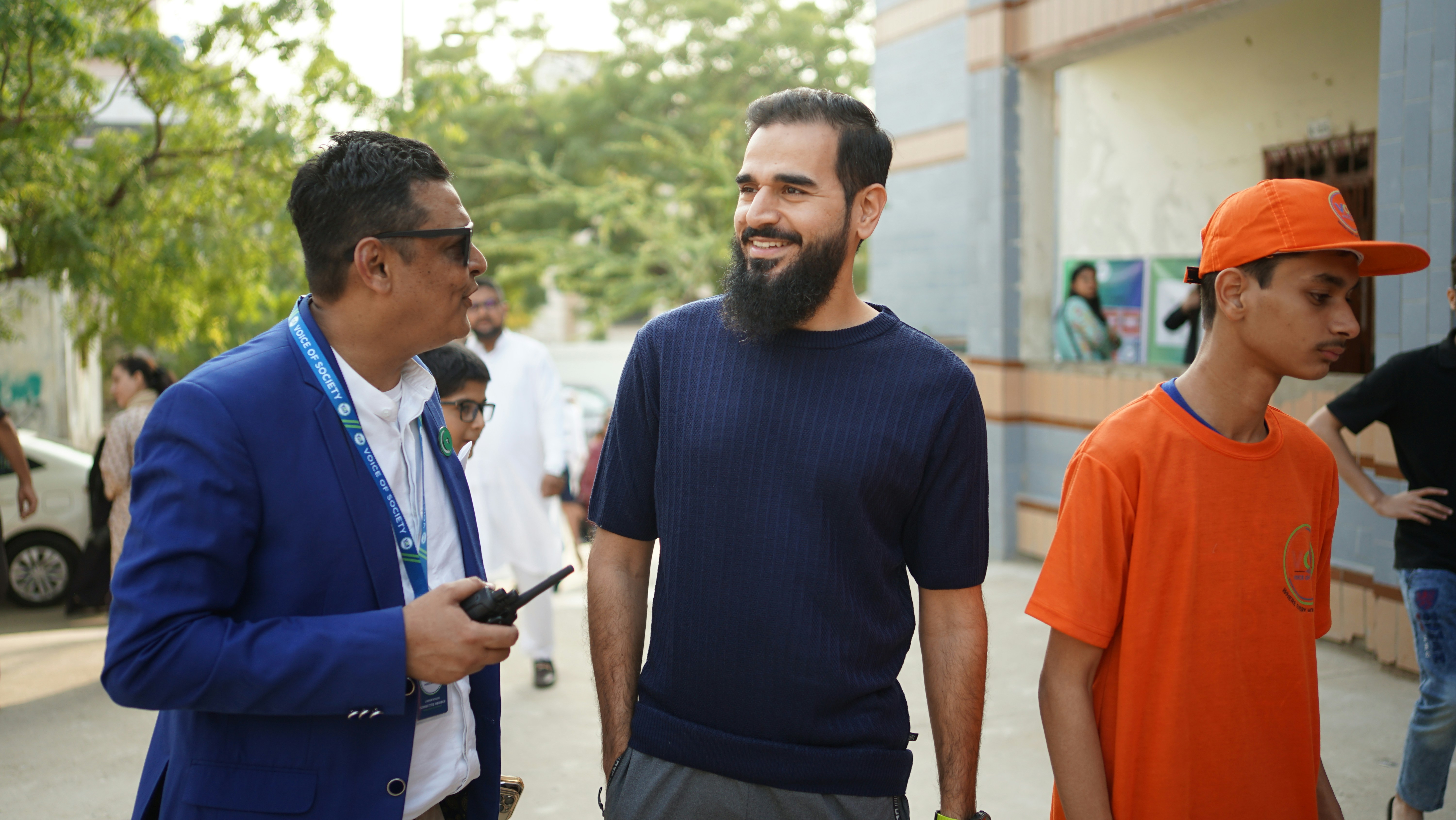 Three men walking and talking outdoors