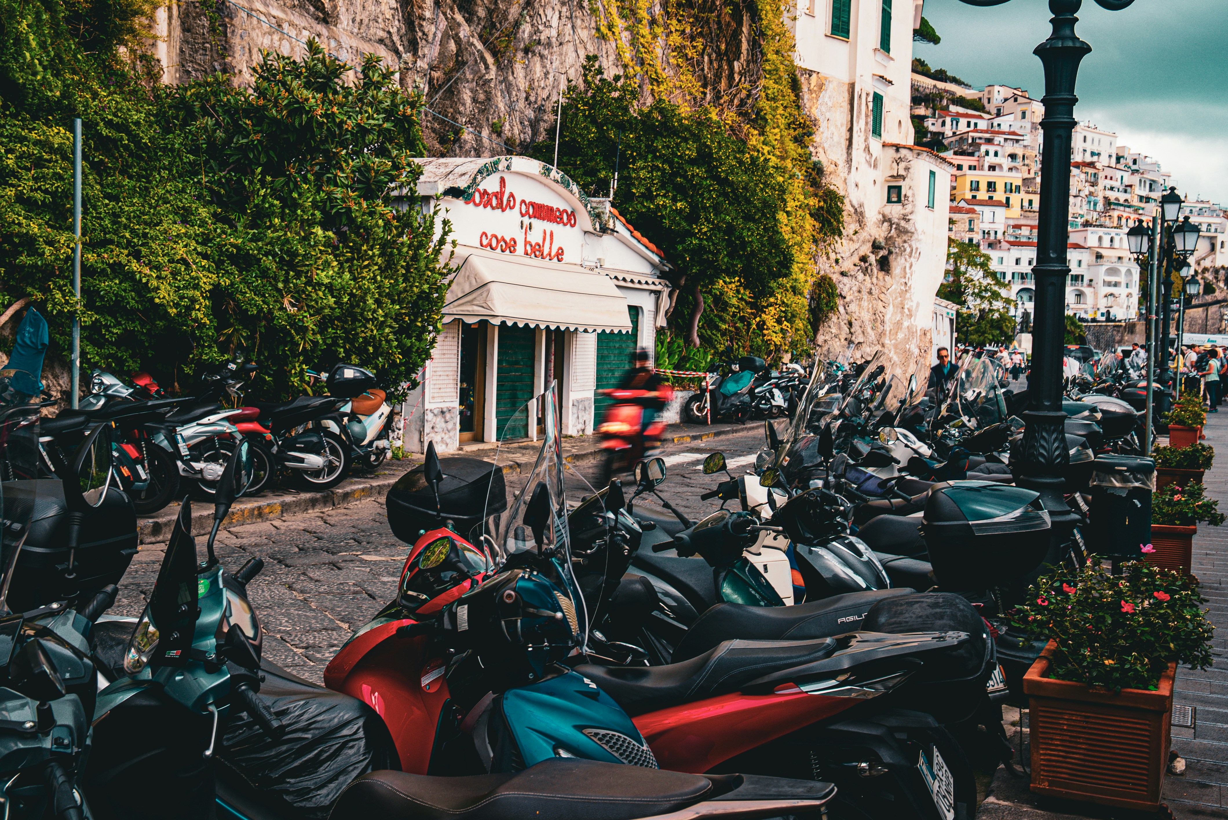 Motorcycles parked along a scenic coastal street.
