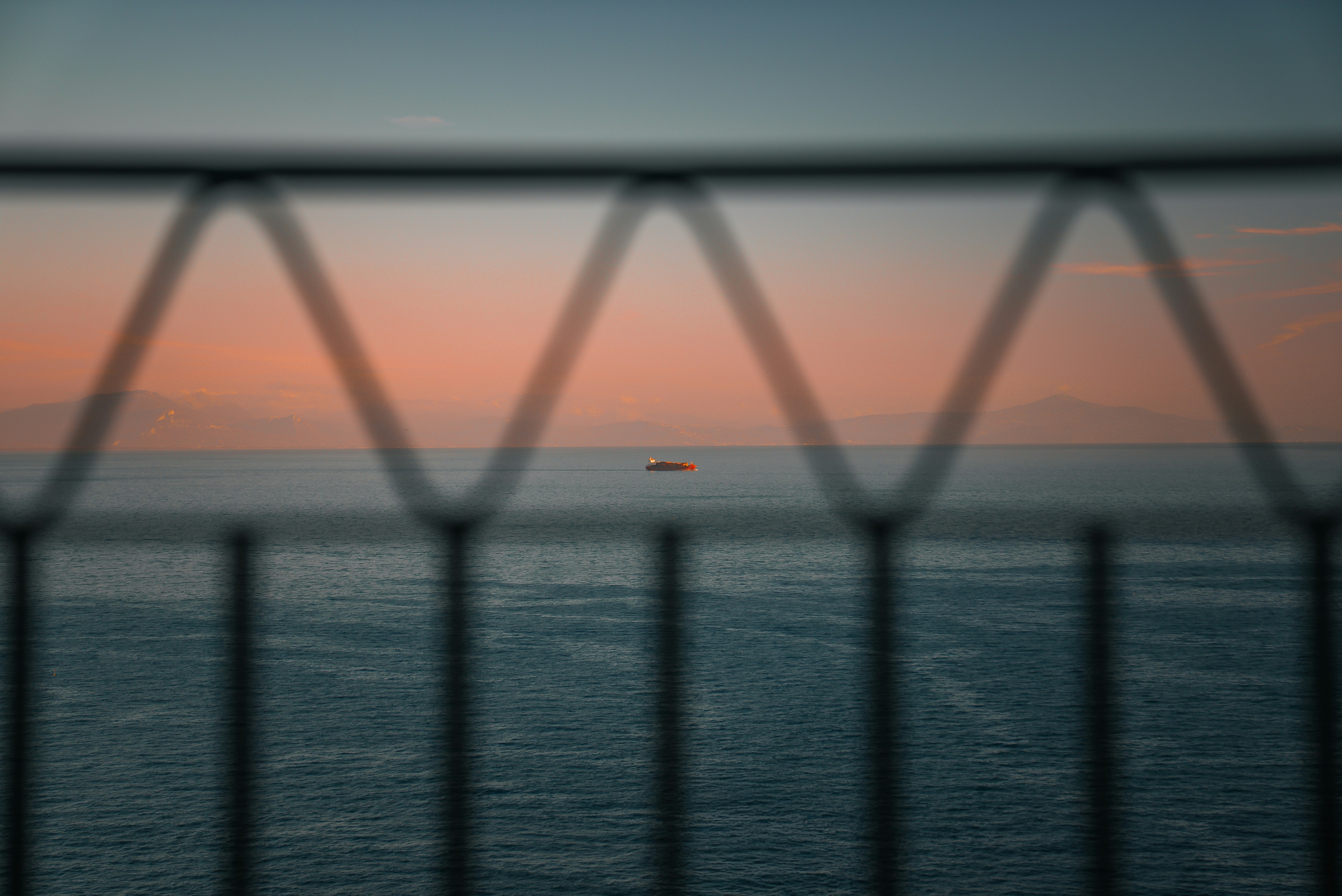 A small boat on the ocean at sunset