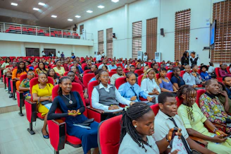 Audience seated in a lecture hall watching a presentation