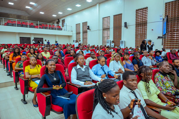 Audience seated in a lecture hall watching a presentation