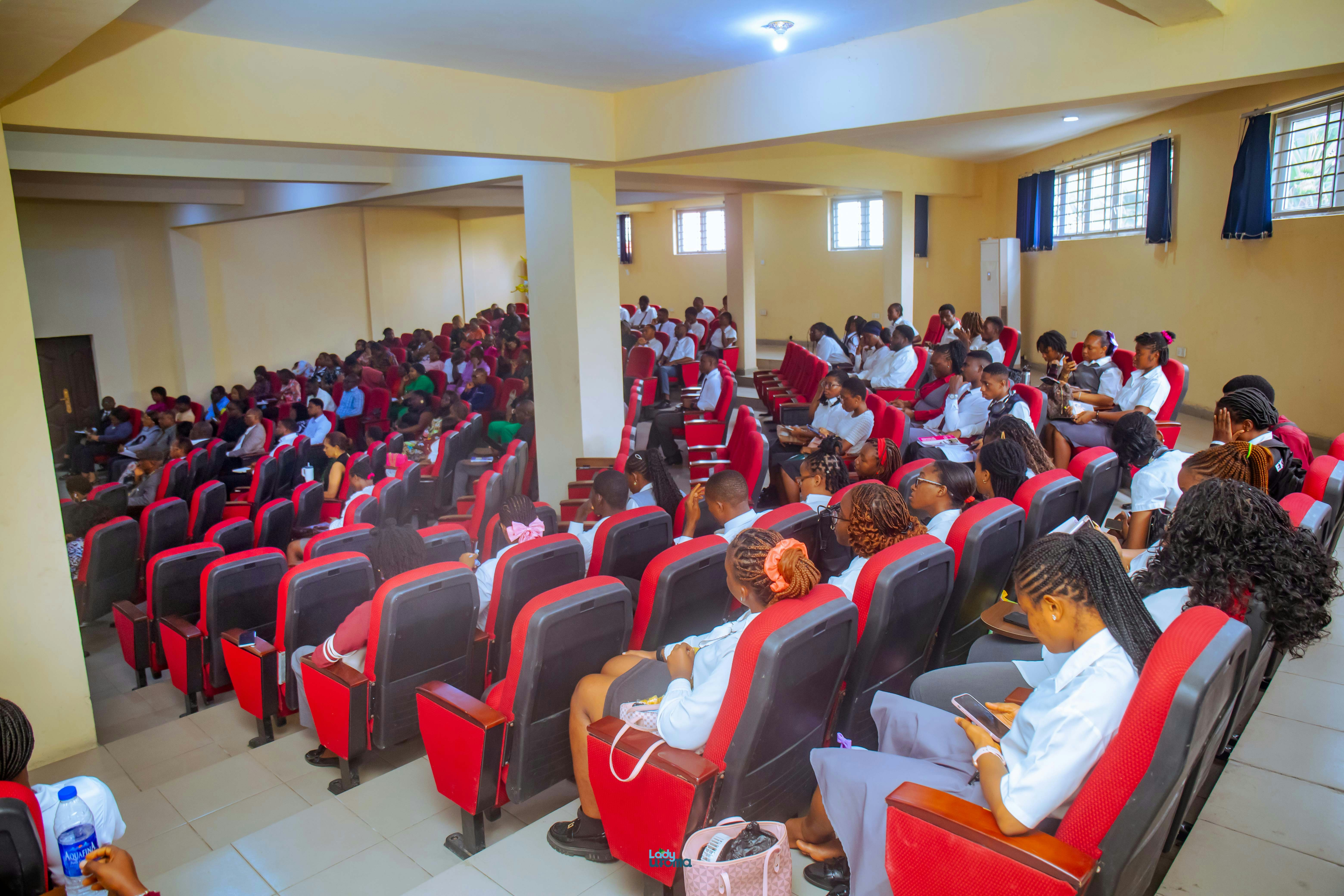 A large group of students sitting in an auditorium.