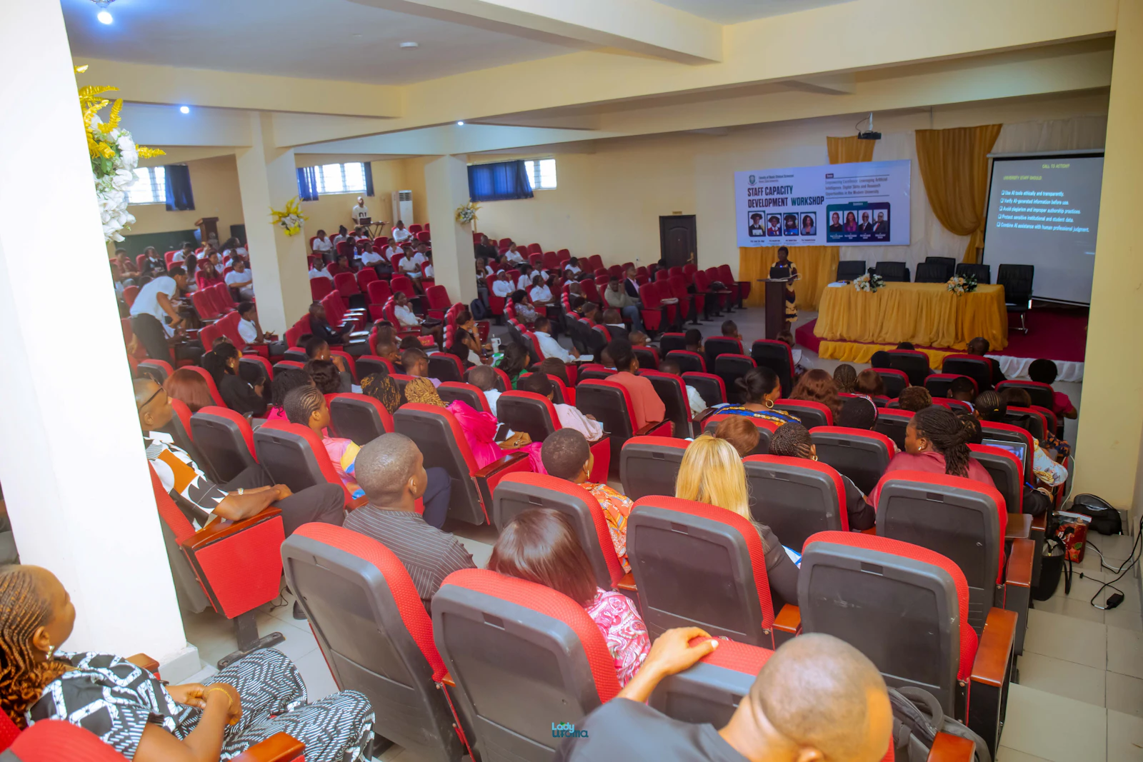 An audience watching a presentation in a conference hall