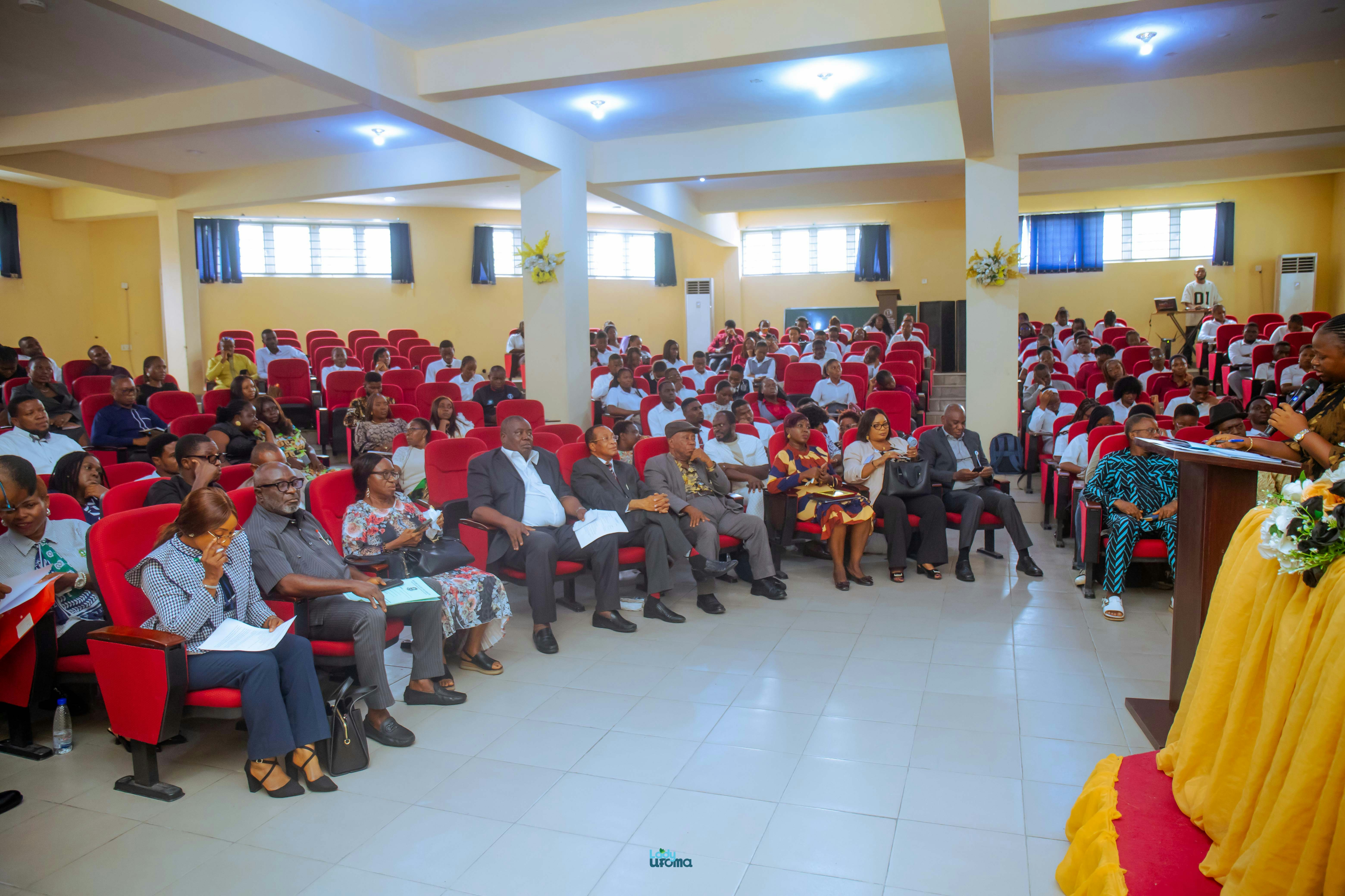 Audience seated in a conference hall during an event.