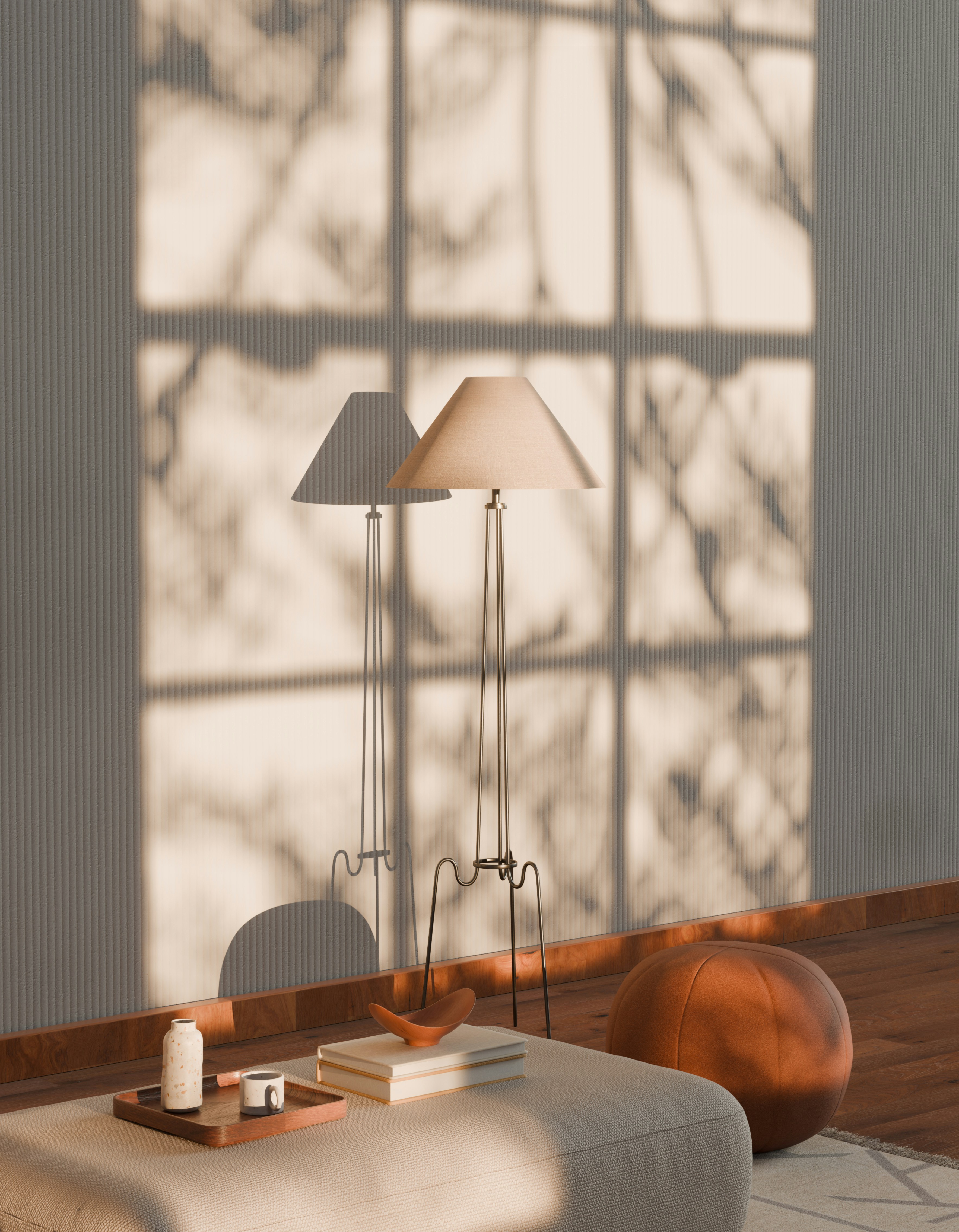 Two floor lamps cast shadows on a wall.