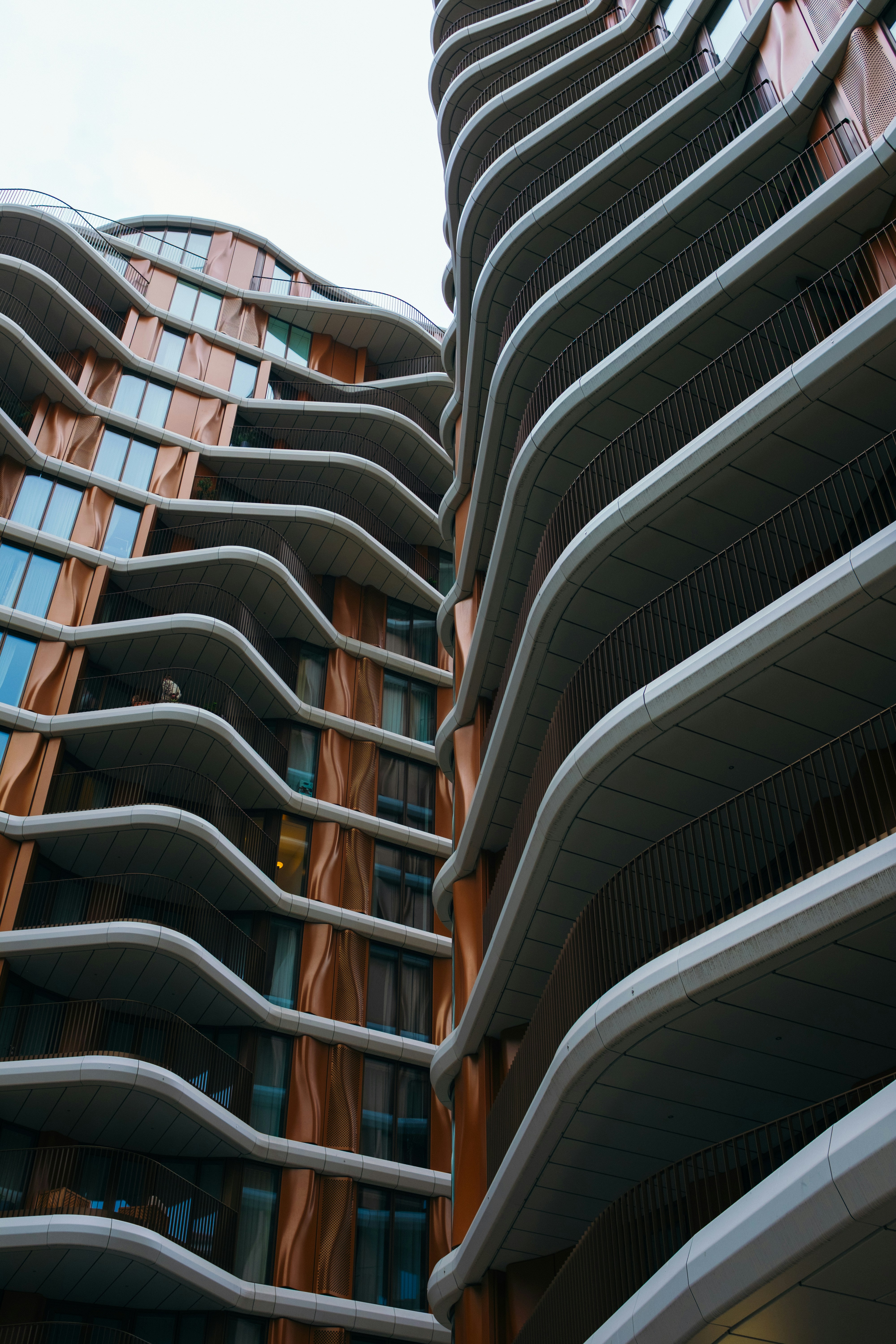 Modern buildings with wavy balconies and copper facade