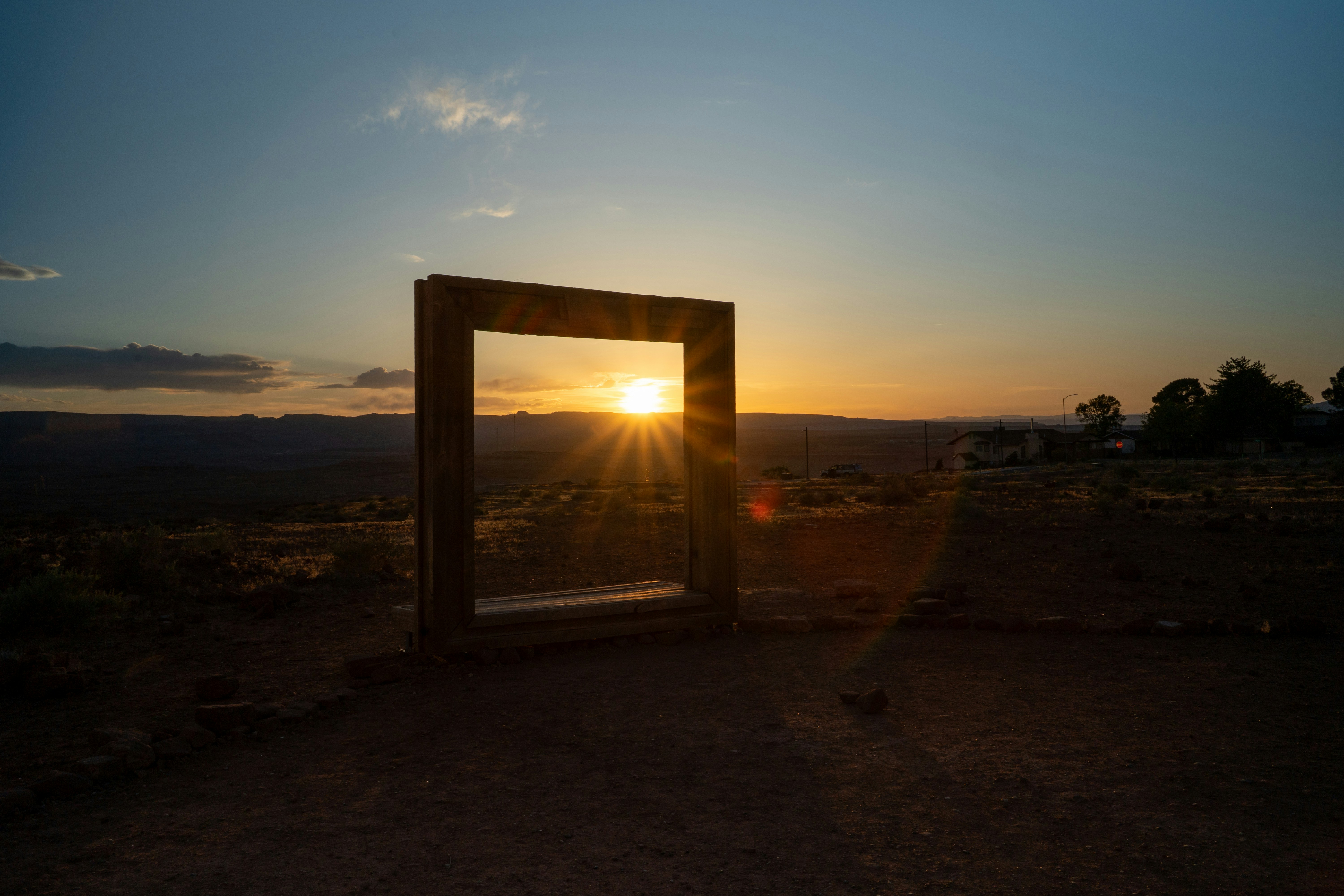 Sunset seen through a wooden frame on a hill
