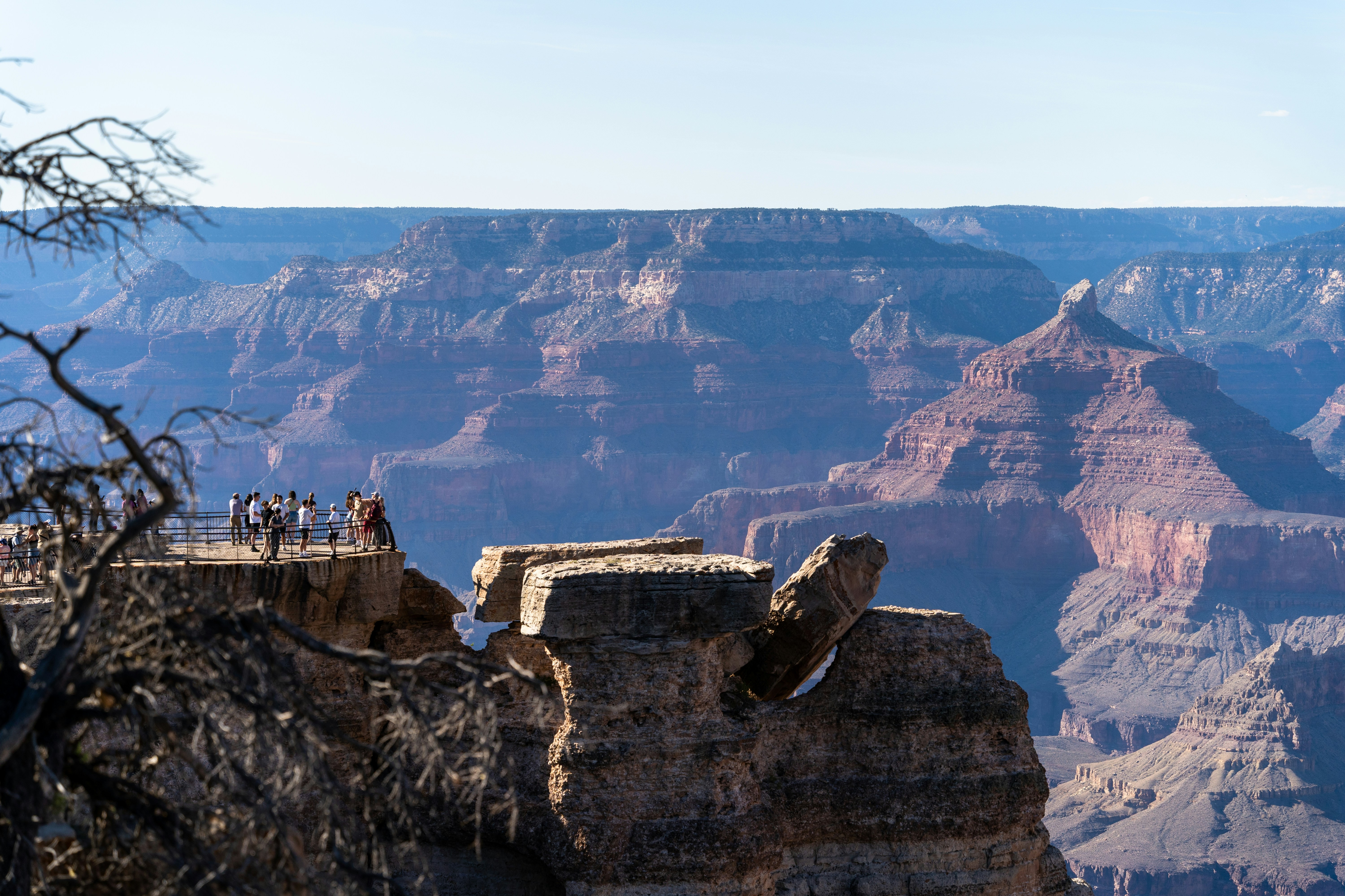 People on a viewing platform overlooking the grand canyon