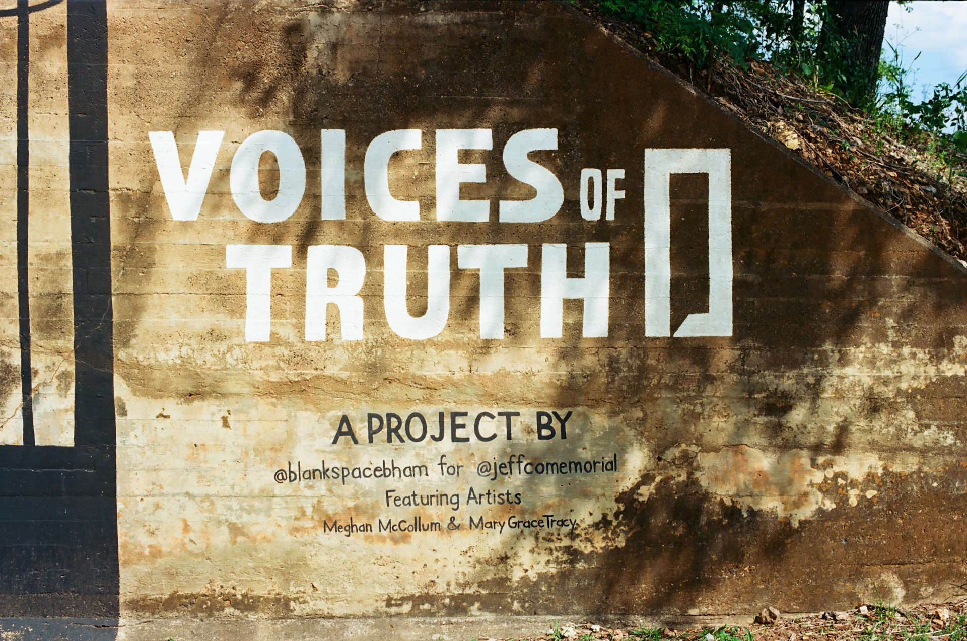 Voices of truth project title on concrete wall