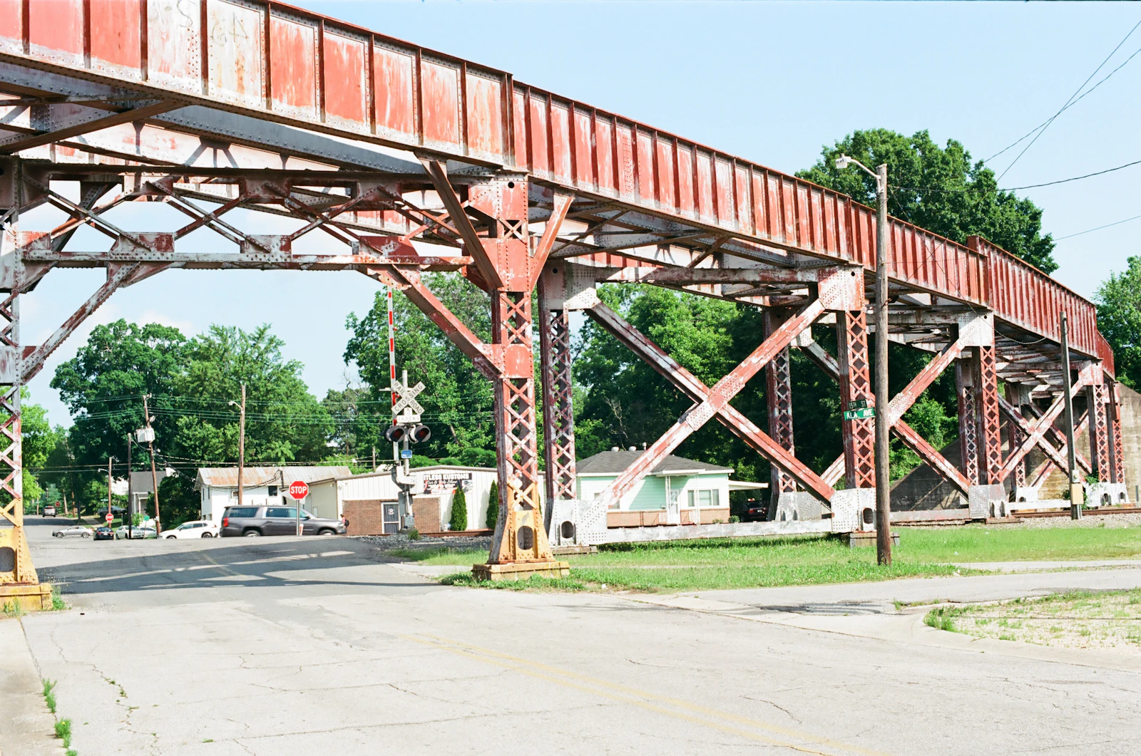 A steel railroad bridge crossing over a street.