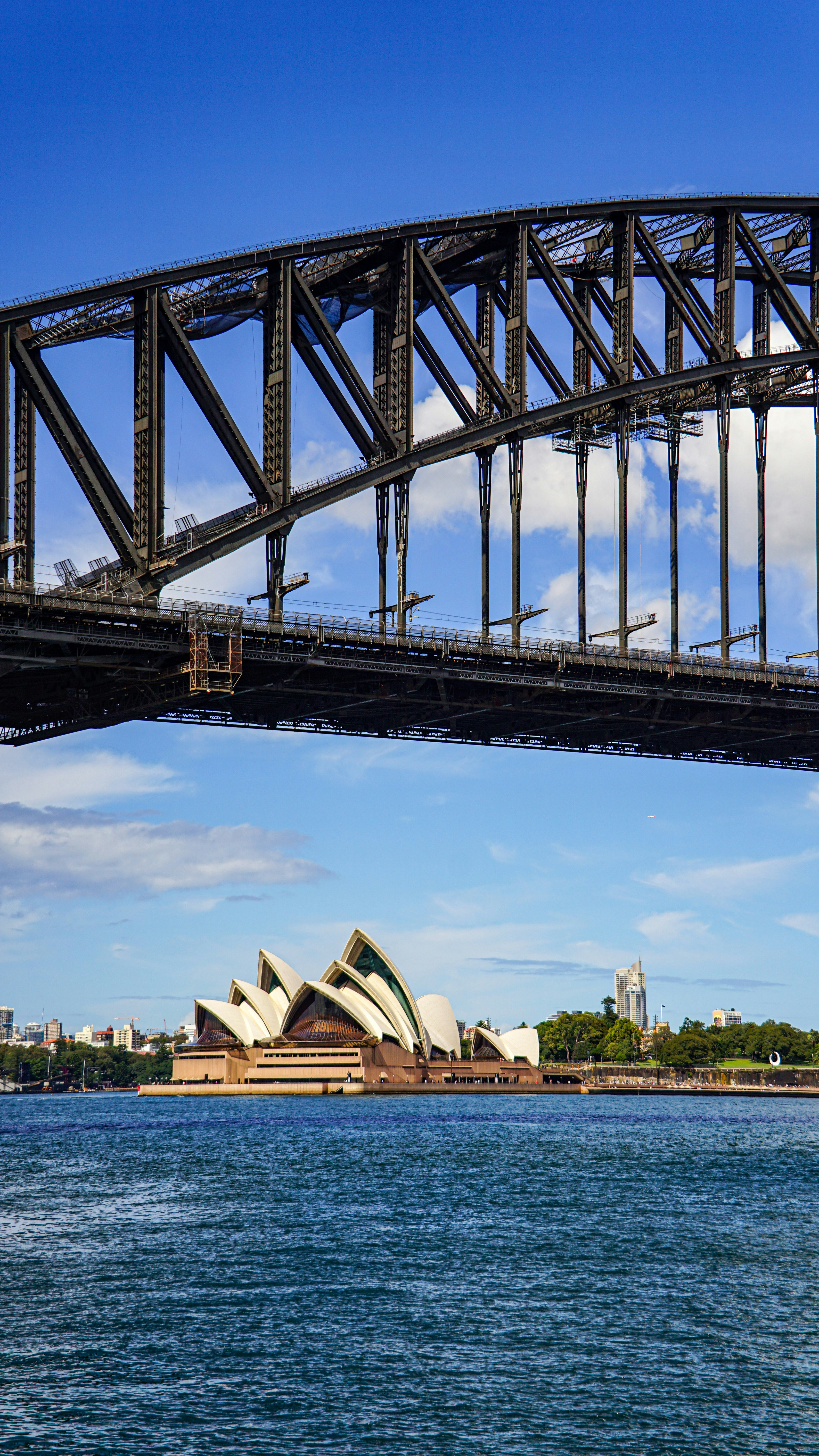 Sydney harbour bridge and opera house under blue sky