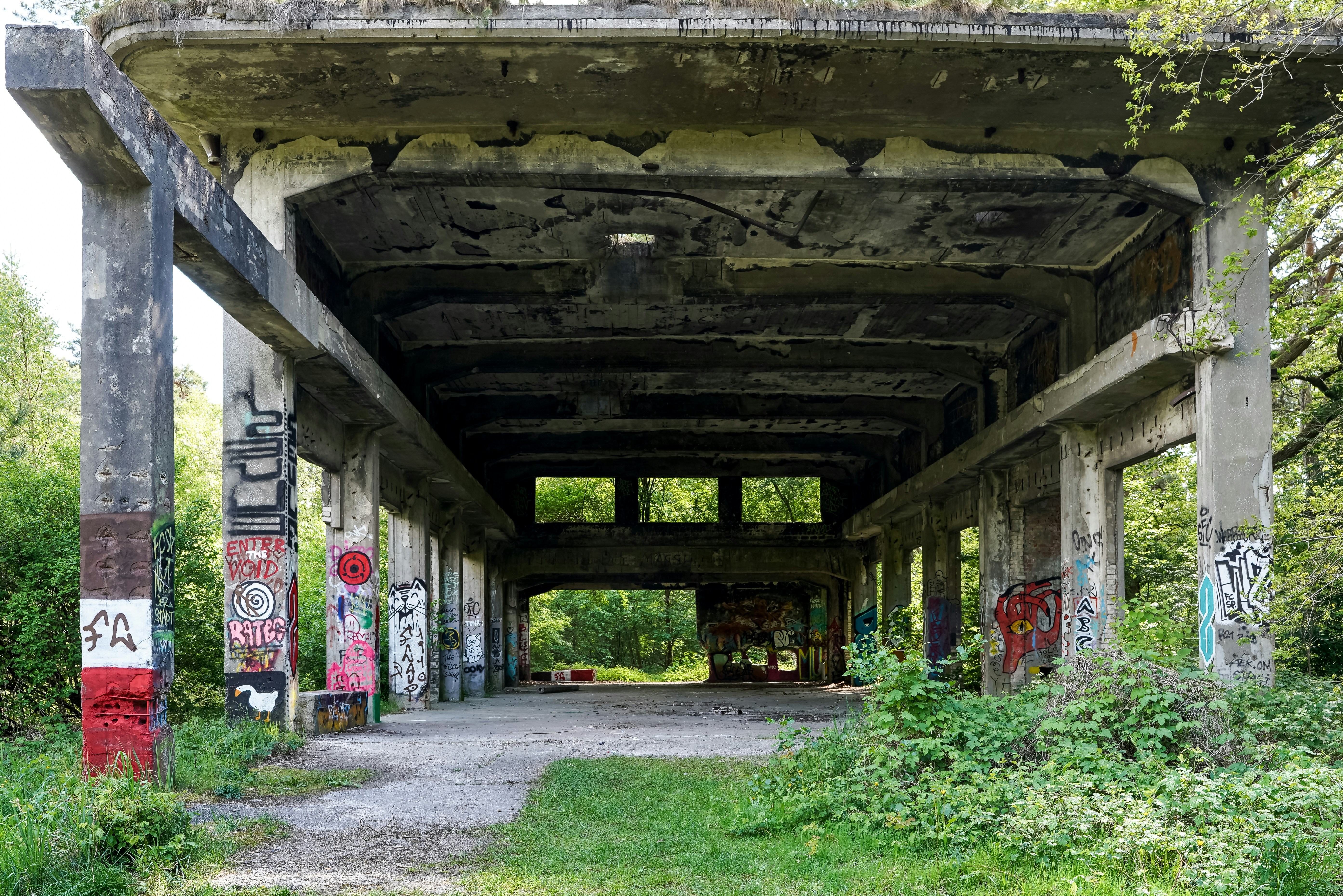 Abandoned concrete structure covered in graffiti outdoors