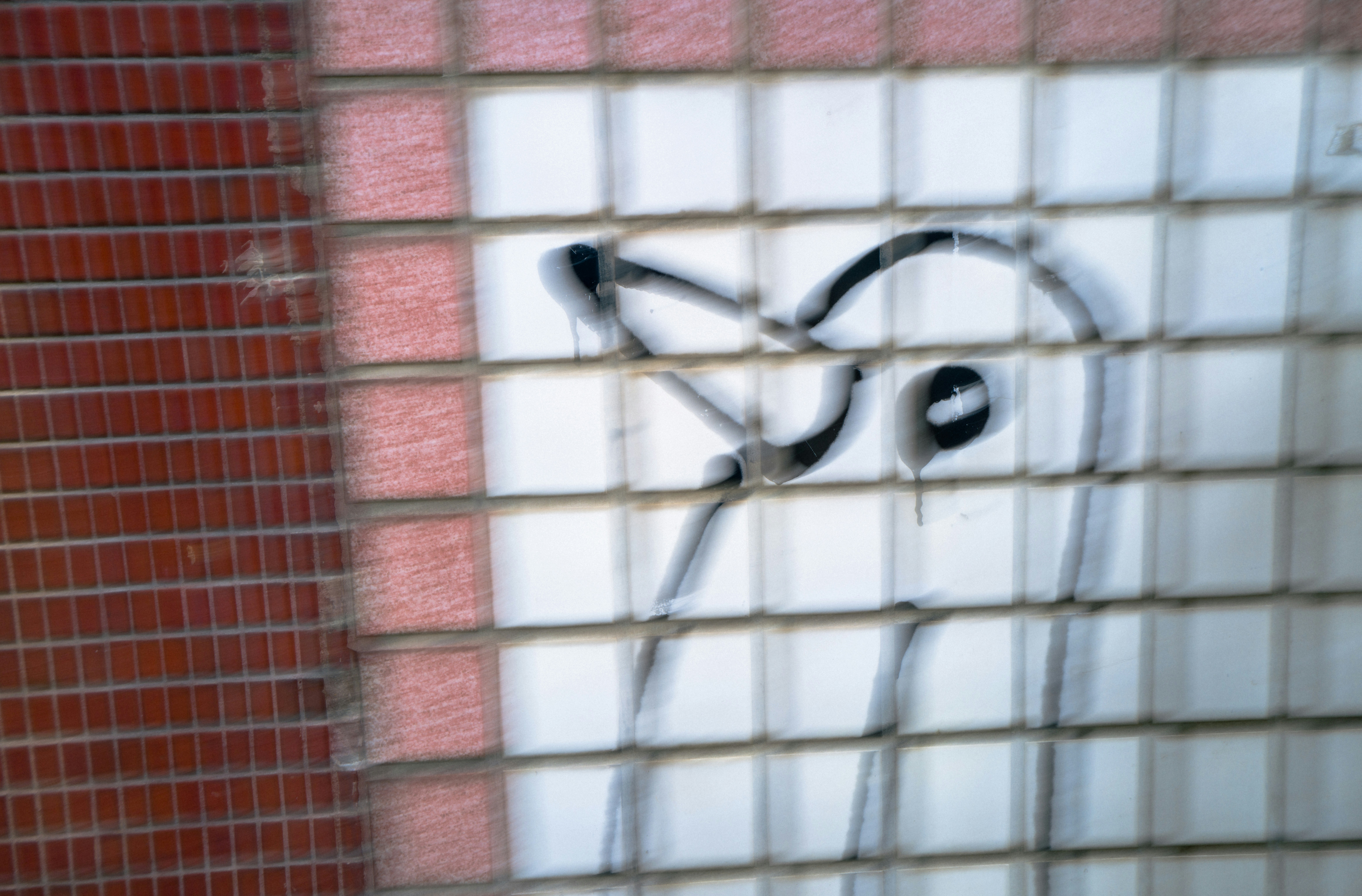 Graffiti art on a tiled wall