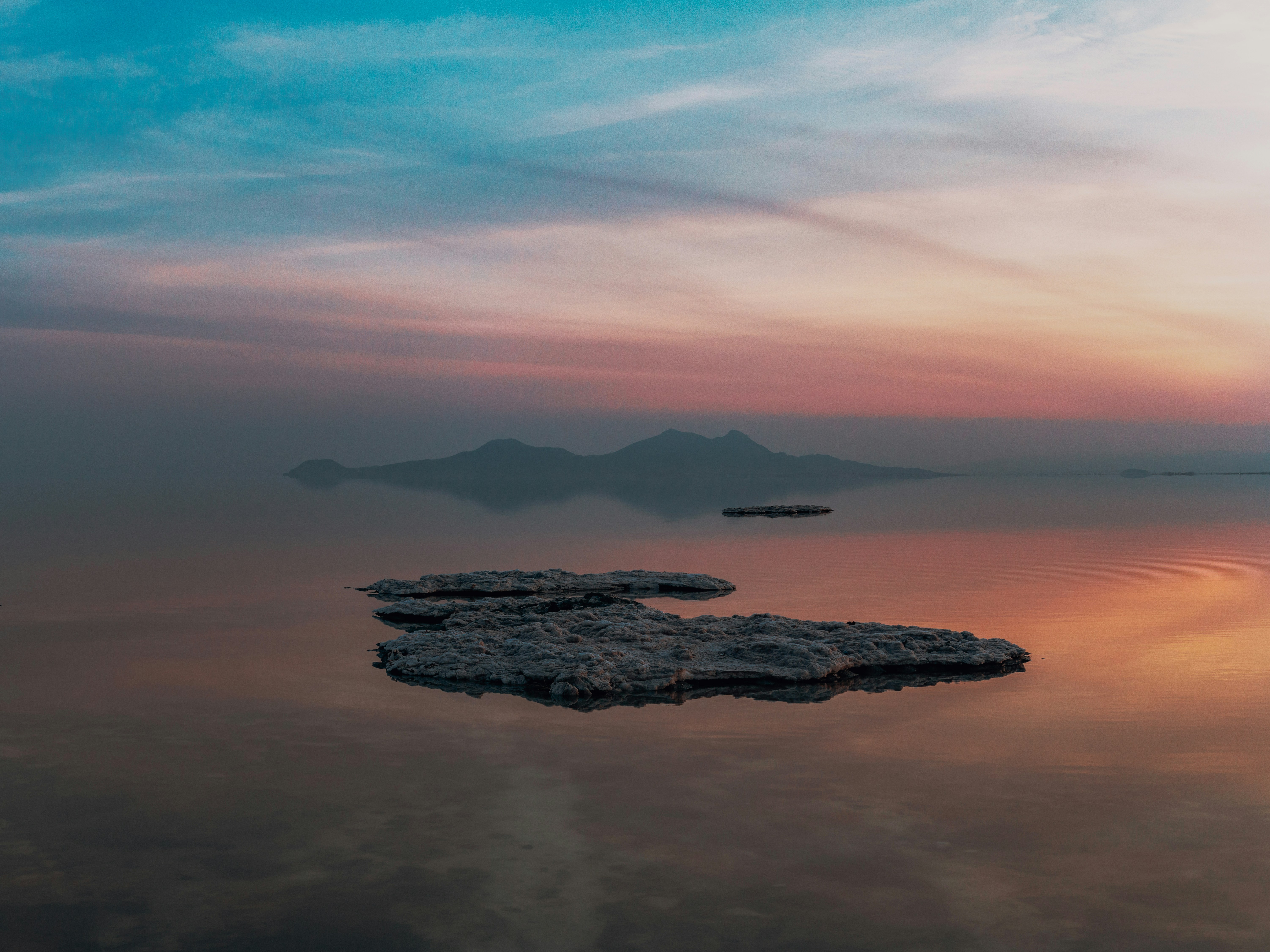 Rocky islands in calm water at sunset
