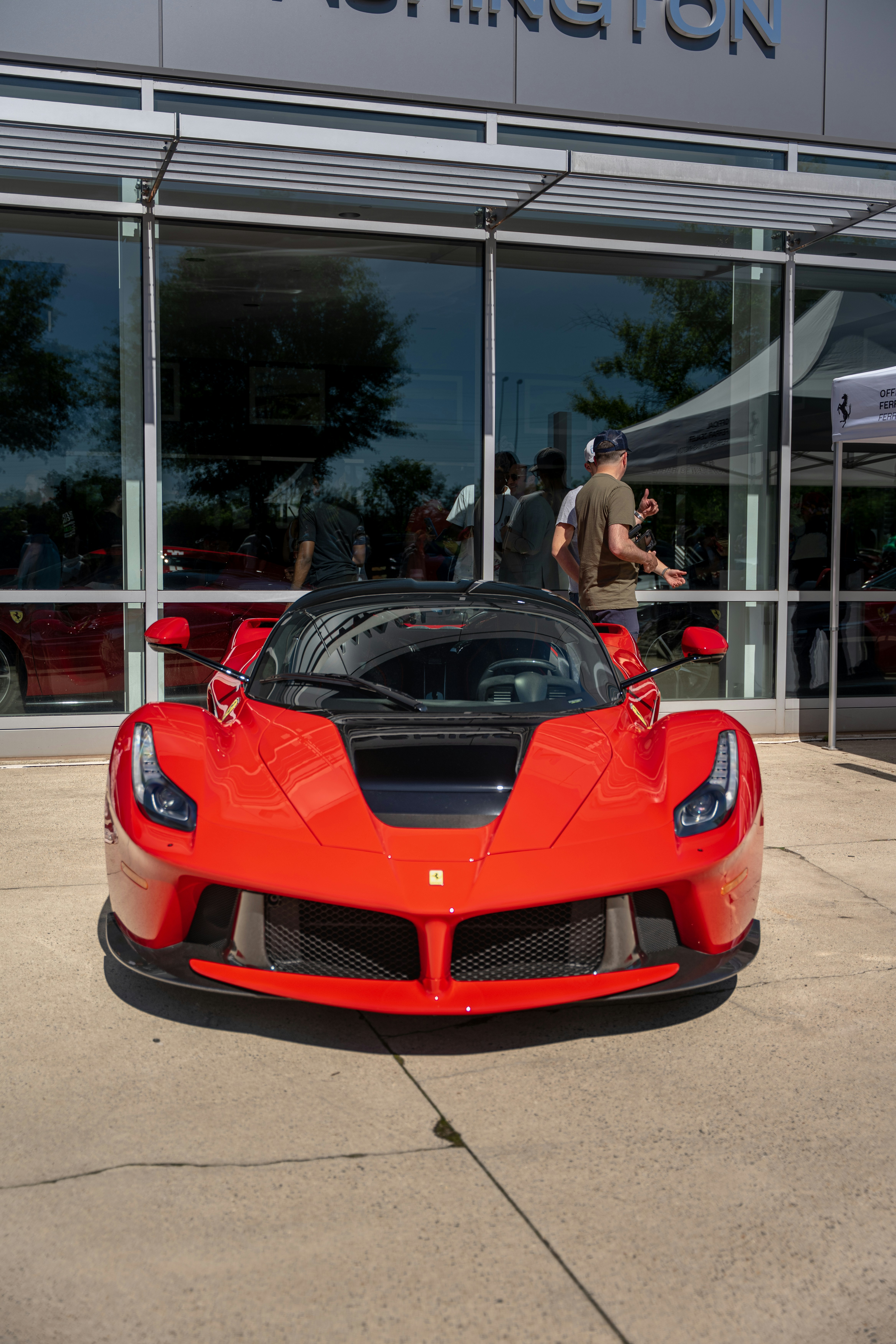 A red ferrari laferrari sports car parked outside a building