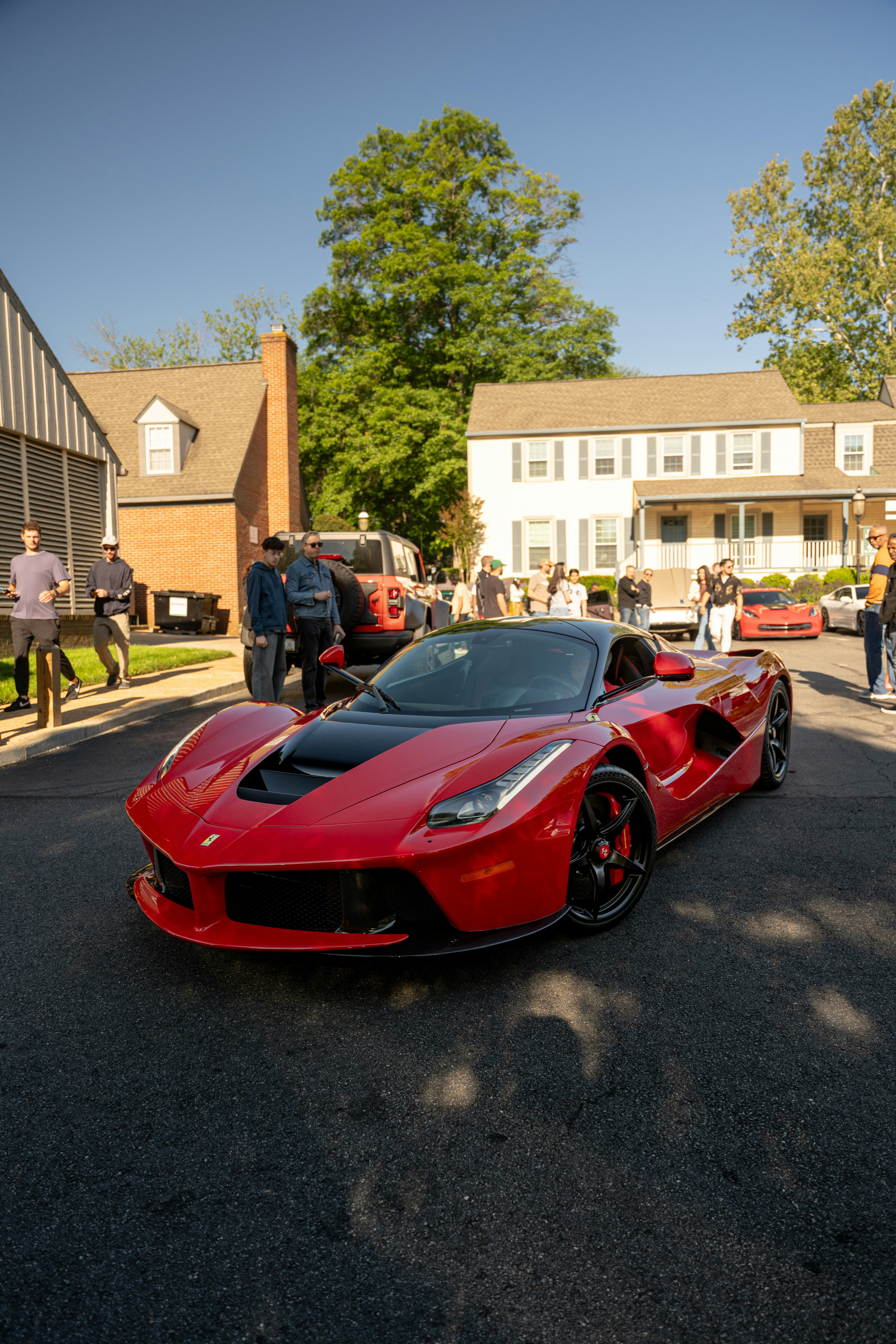Red ferrari laferrari sports car parked on a sunny street