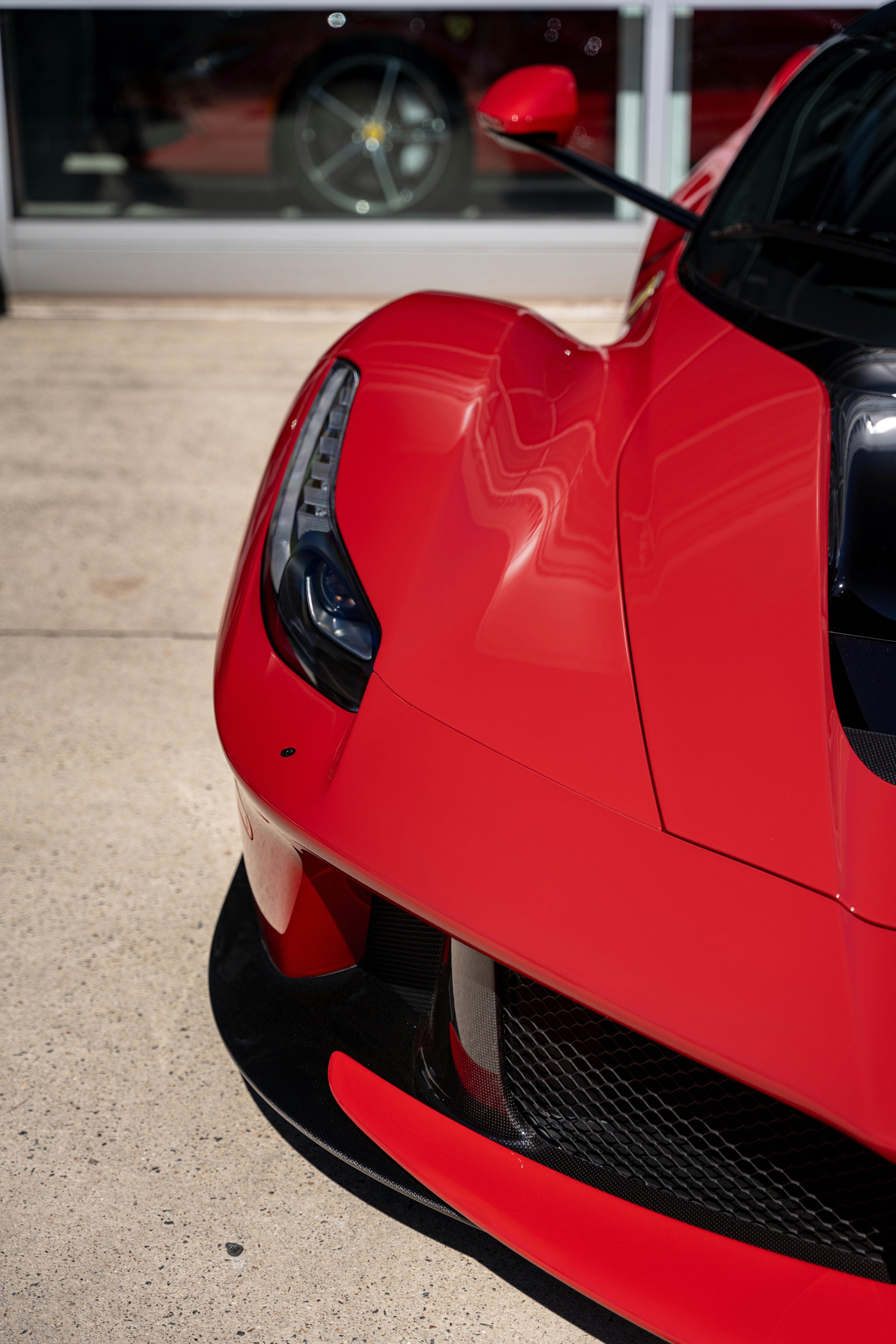 Front of a sleek red sports car