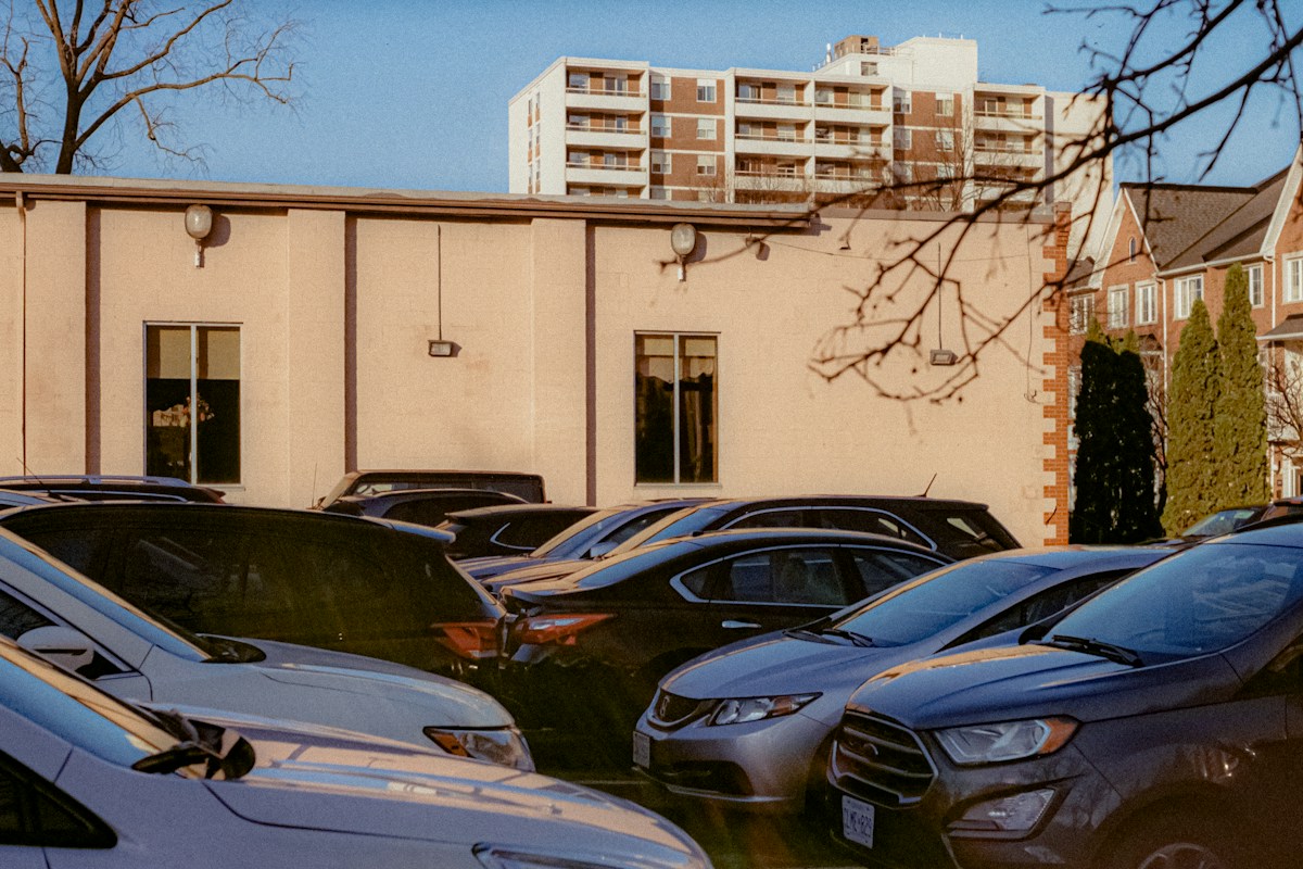Cars parked in a lot with buildings in the background, unrelated to team building exercises for youth sports.