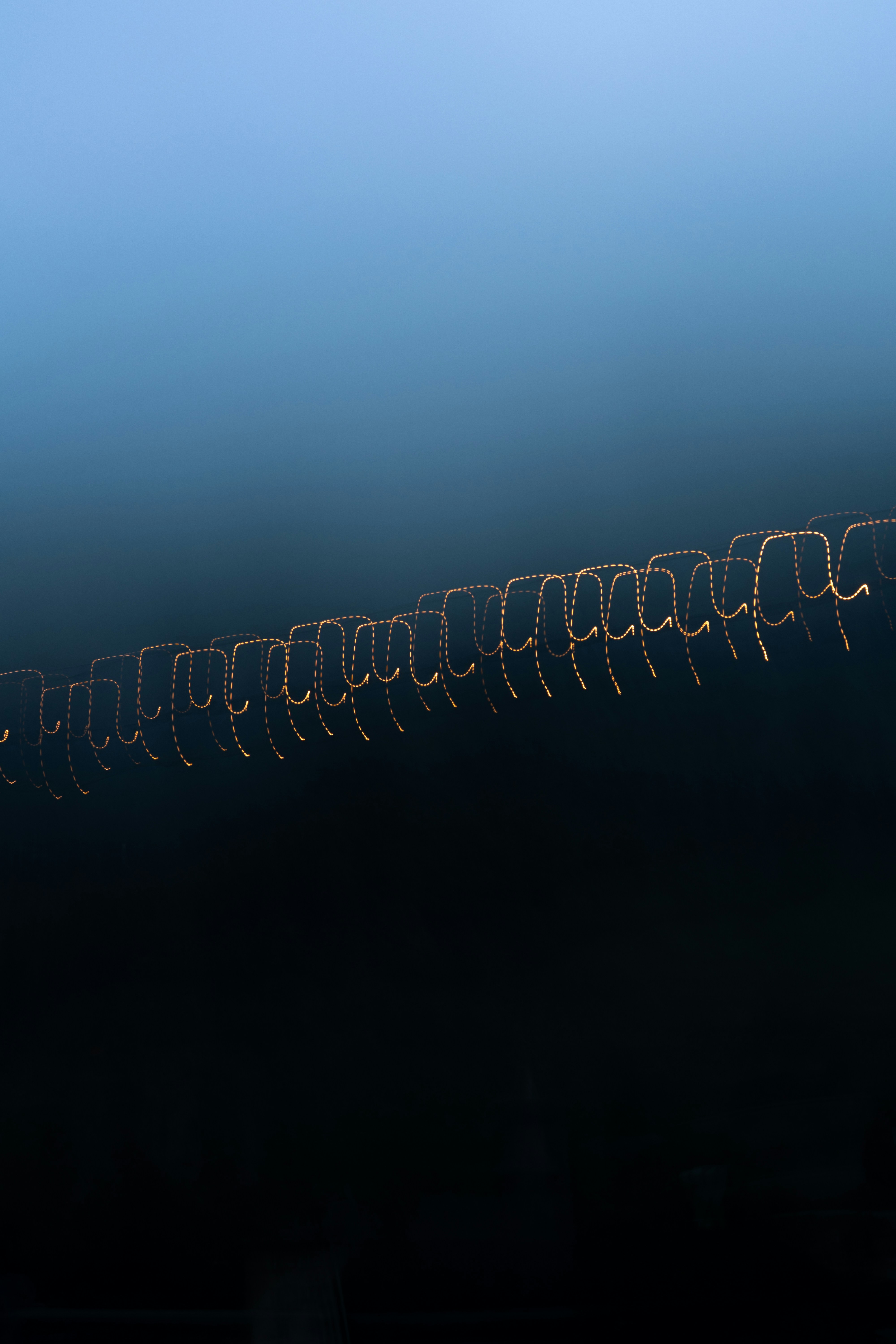 Photo of Abstract pattern of glowing lights against dark background by Max Bürgi