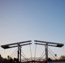 A drawbridge is open against a clear sky.