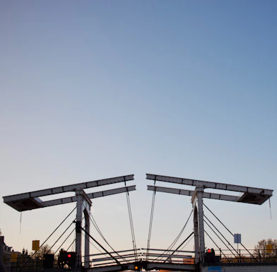 A drawbridge is open against a clear sky.