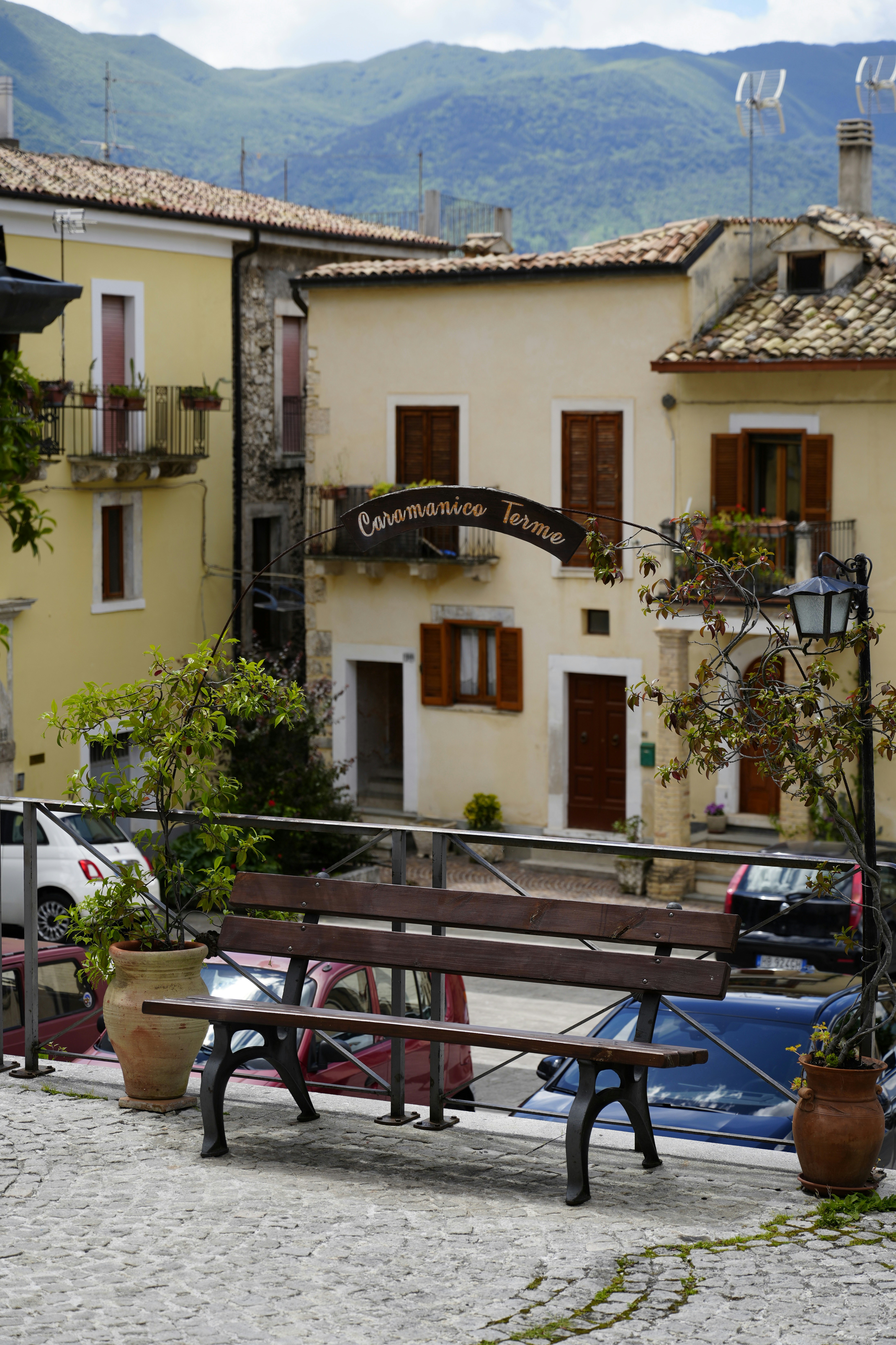 Bench on cobblestone street with old buildings