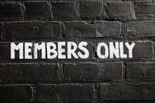 Members only sign on a brick wall