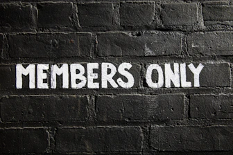 Members only sign on a brick wall