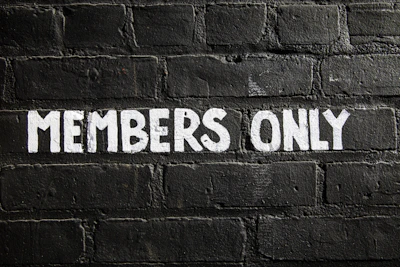 Members only sign on a brick wall