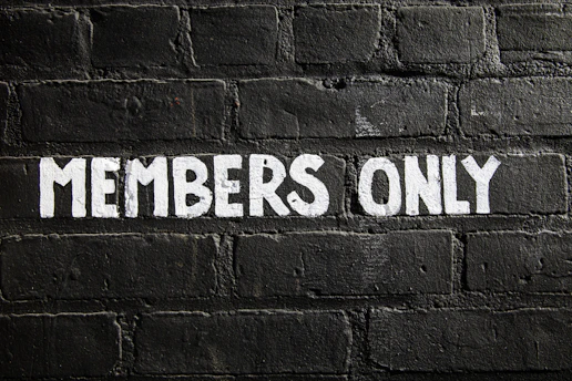 Members only sign on a brick wall