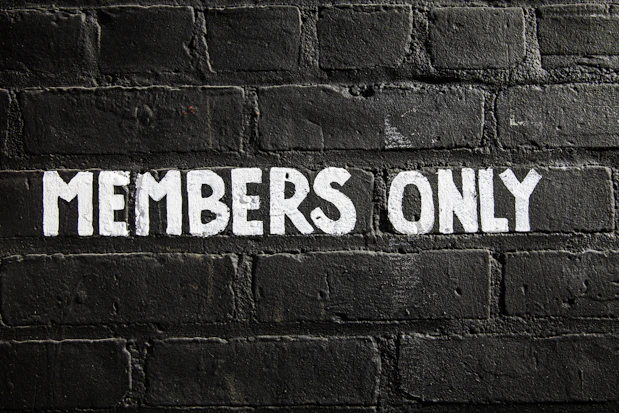 Members only sign on a brick wall