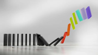 Colorful dominoes falling in a chain reaction