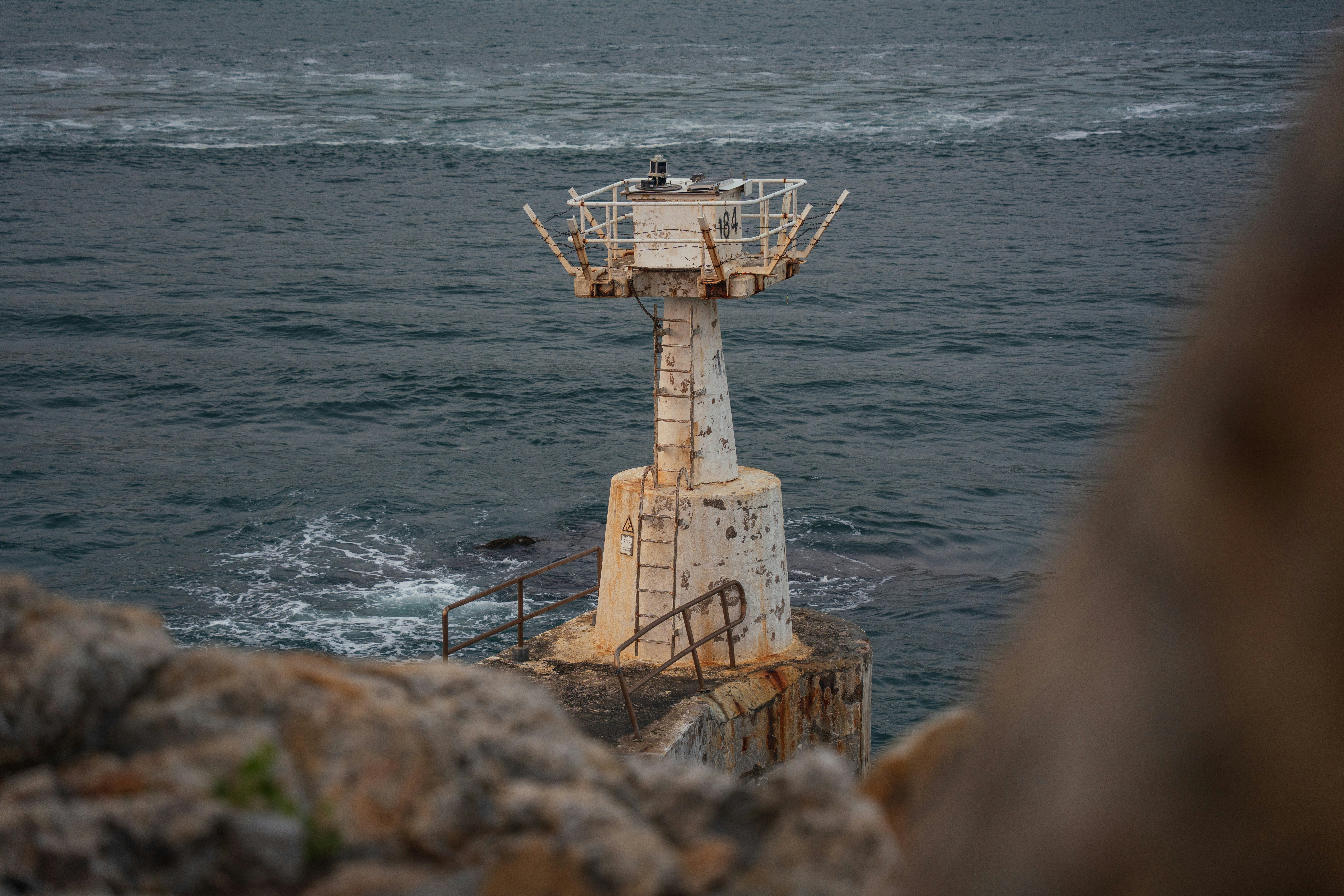 Old lighthouse on a rocky shore overlooking the ocean