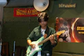 A young person plays an electric guitar indoors