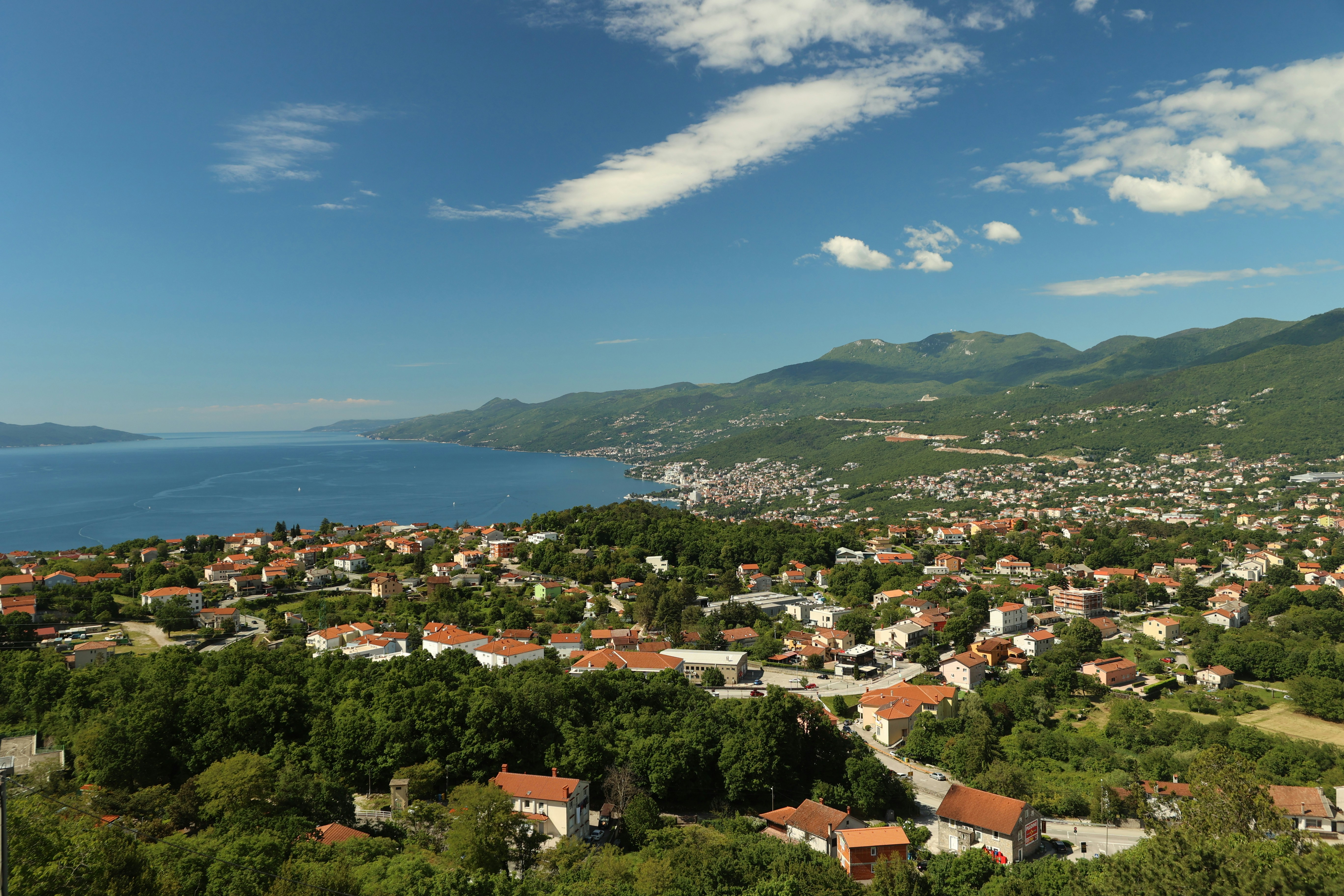 Eine malerische Küstenstadt, eingebettet am Meer und an den Bergen.