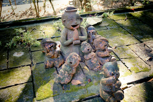 Clay figures of children gathered around an adult