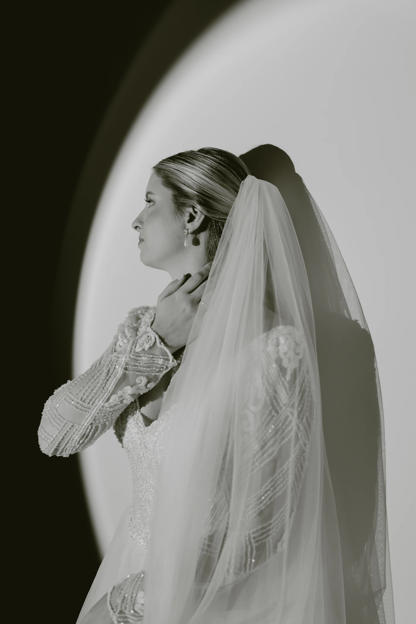 How to sew your own wedding veil — A bride adjusting her simple, handmade tulle veil before the ceremony.