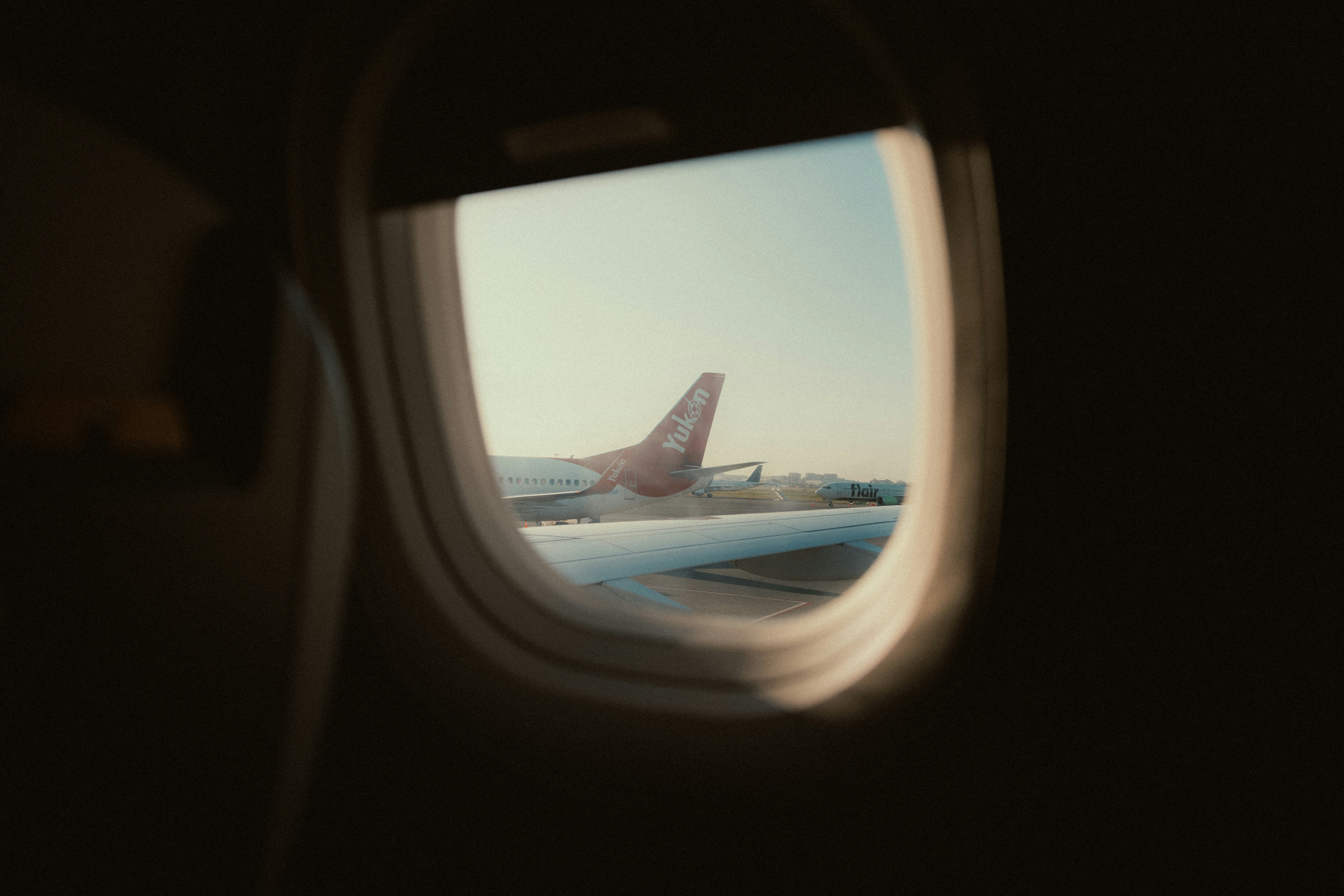 View from airplane window of another plane on tarmac