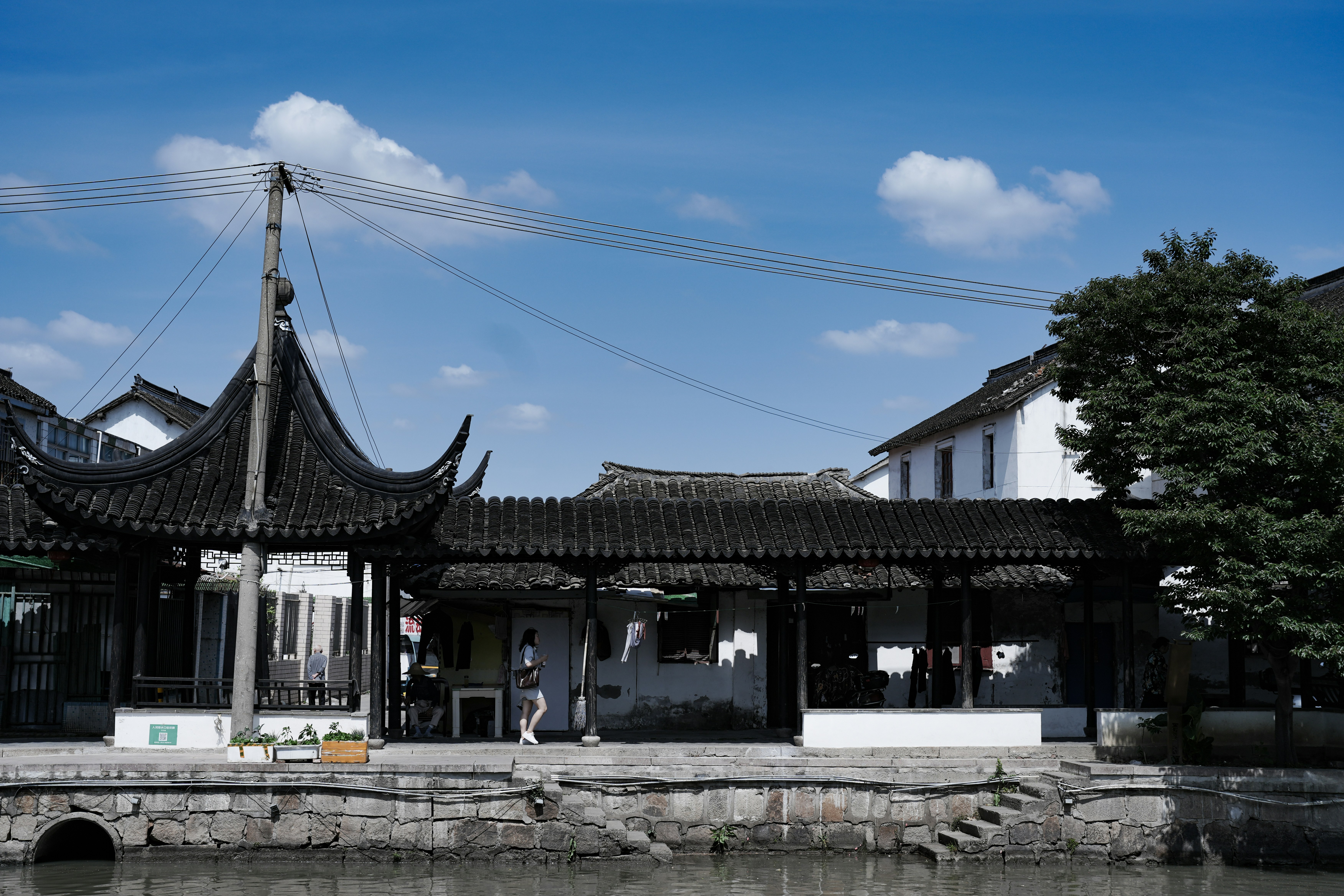 Traditional chinese pavilion and covered walkway by a canal
