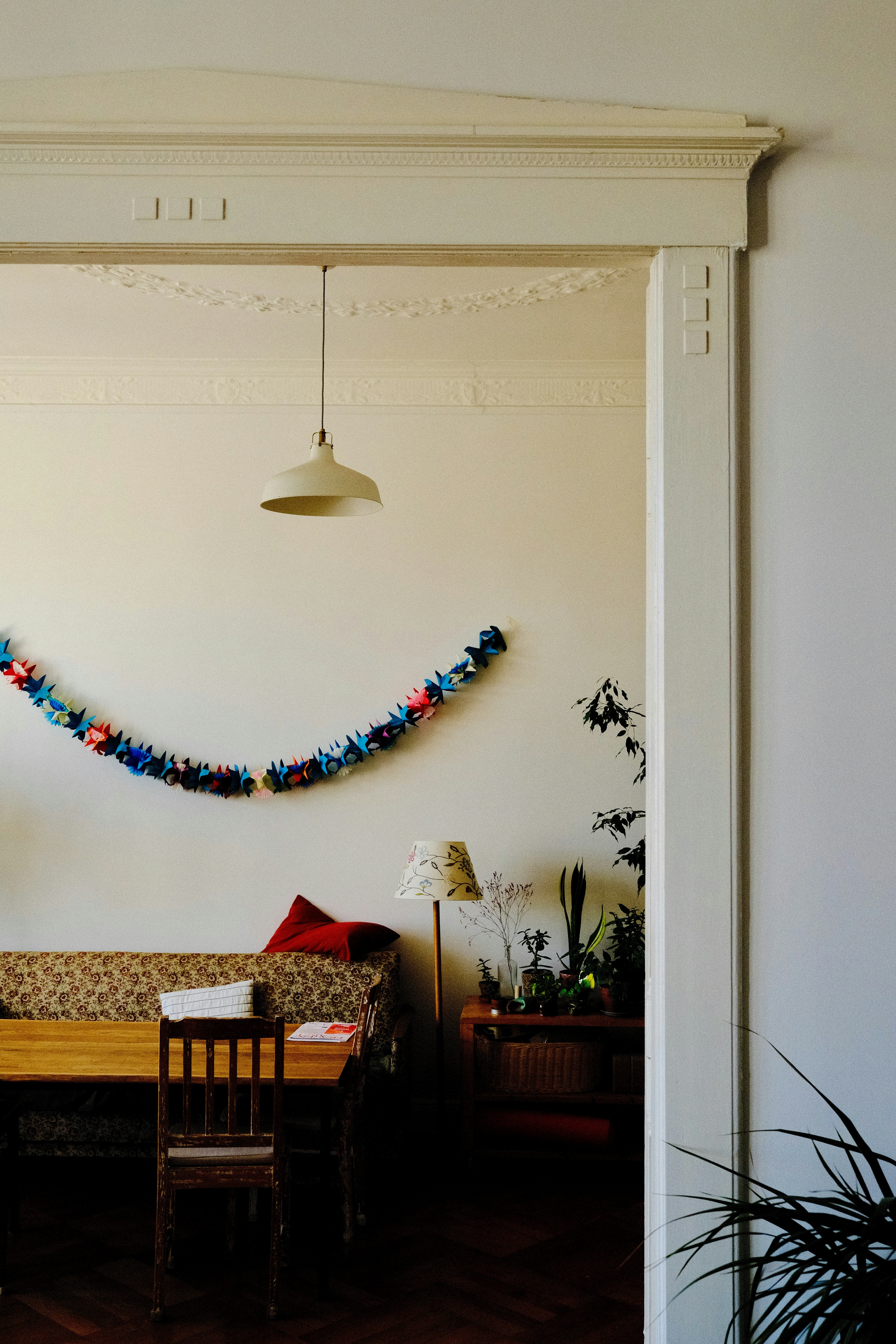A festive garland hangs above a sofa and table.