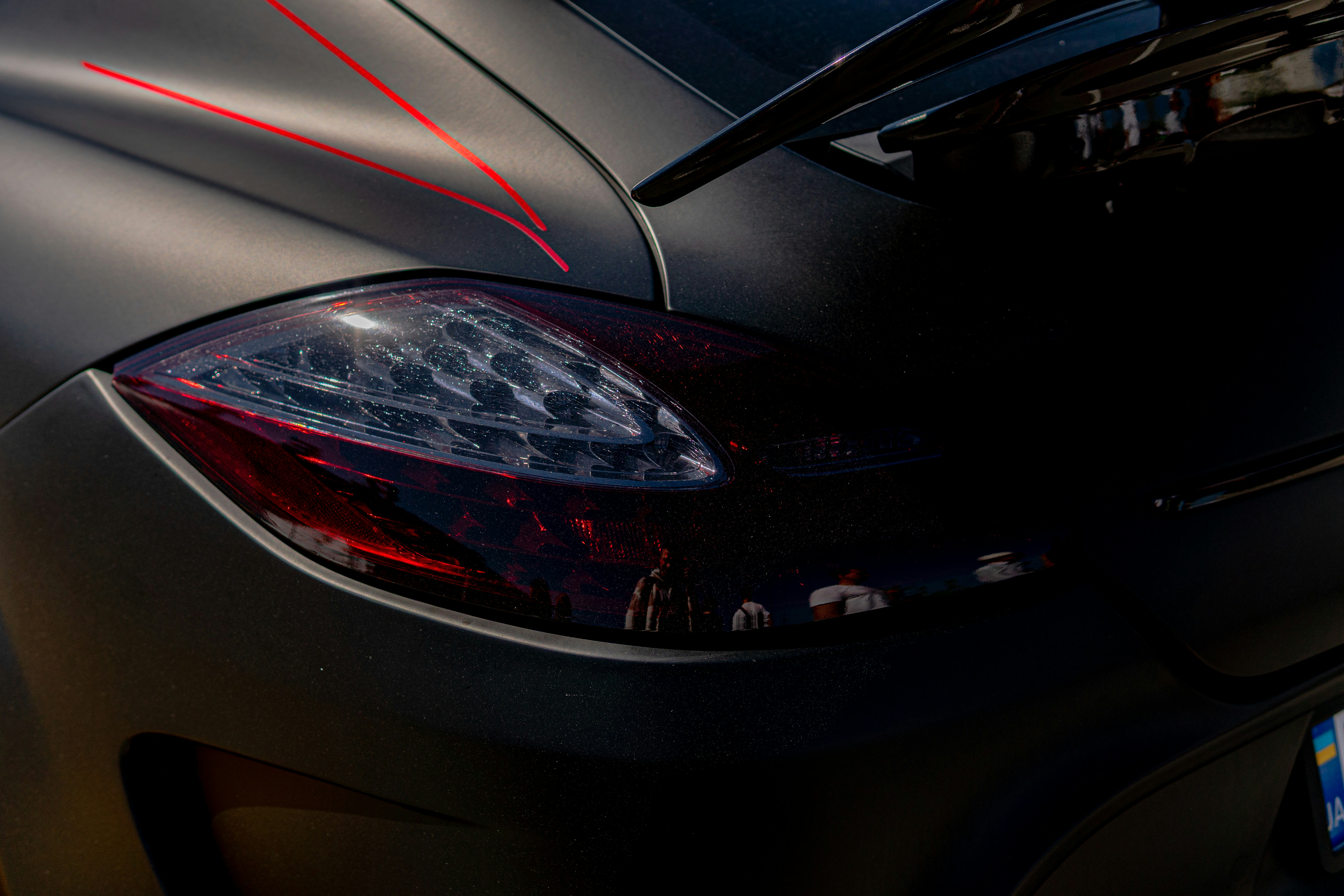 Dark car's taillight with red accents