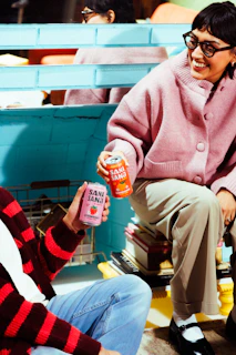 Lifestyle product photography of a person holding a beverage can
