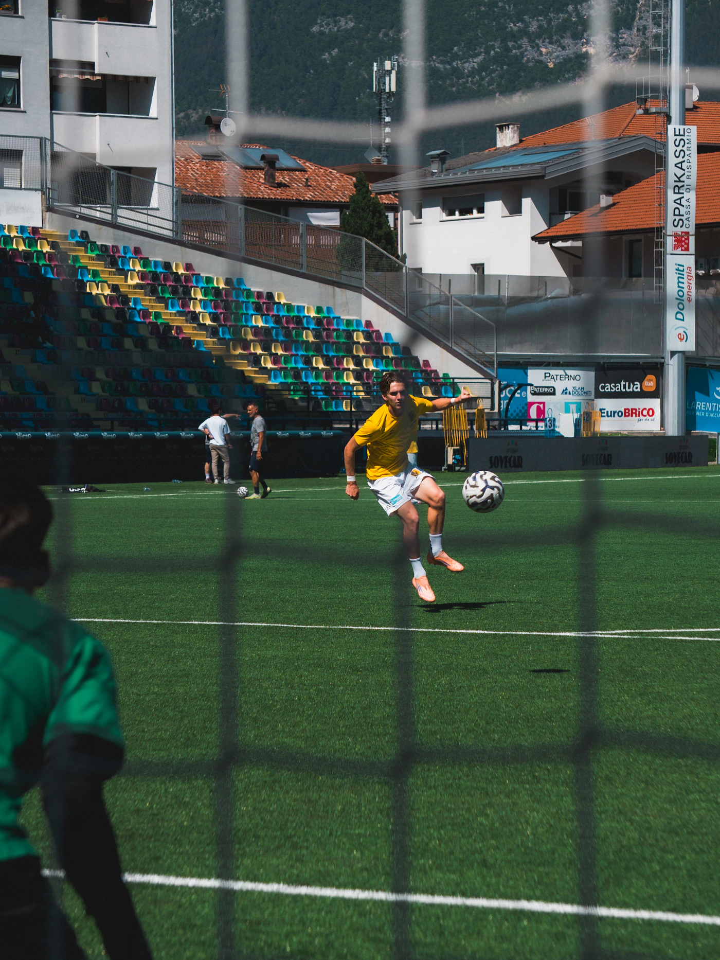 Football player controlling a ball on the pitch
