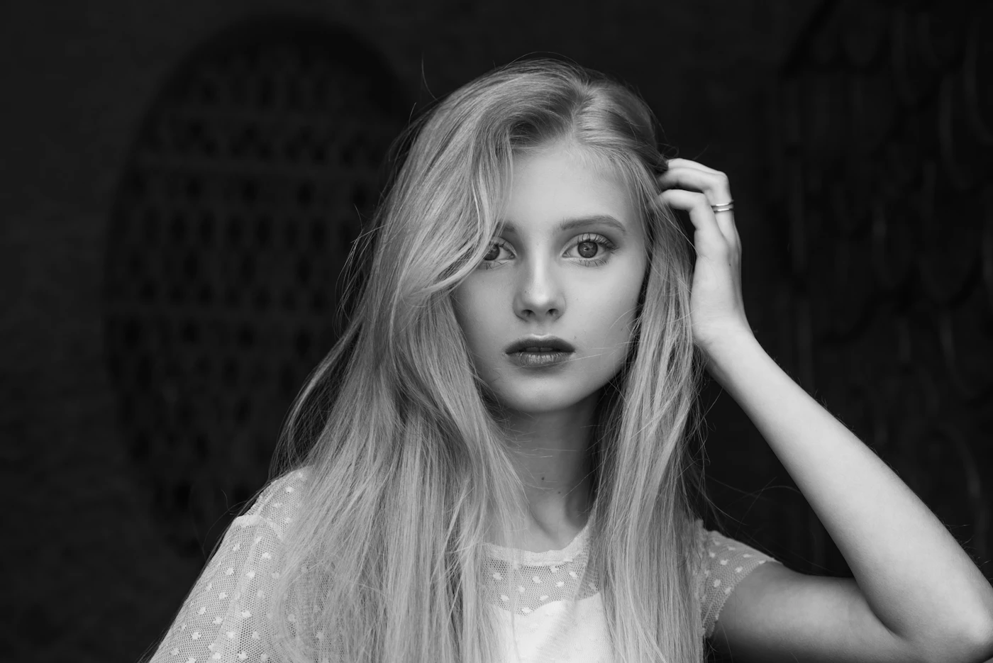 Black and white, soft portrait in a dark doorway